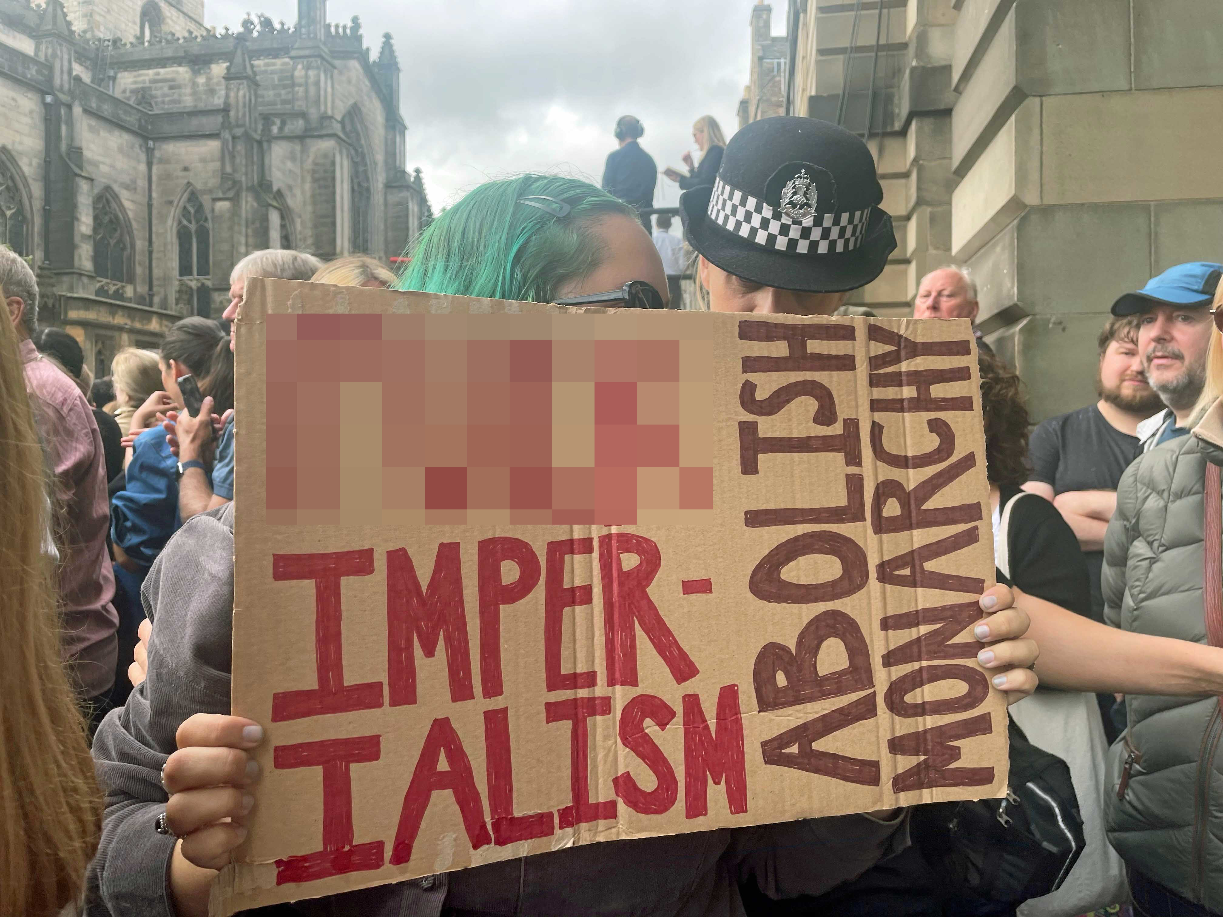 A protester before the Accession Proclamation Ceremony at Mercat Cross, Edinburgh