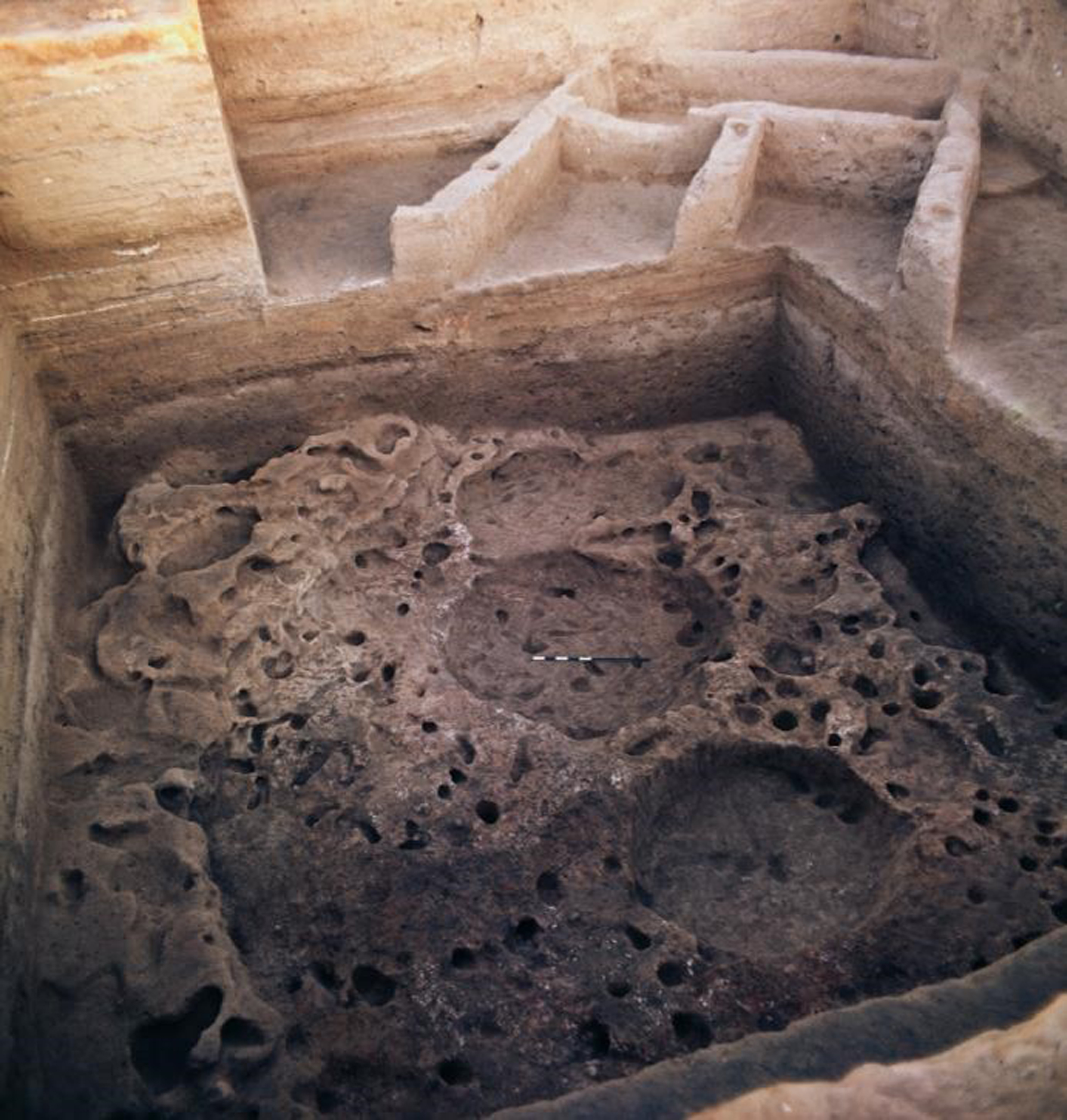 A rectangular Neolithic period house lying above an older oval-shaped hut