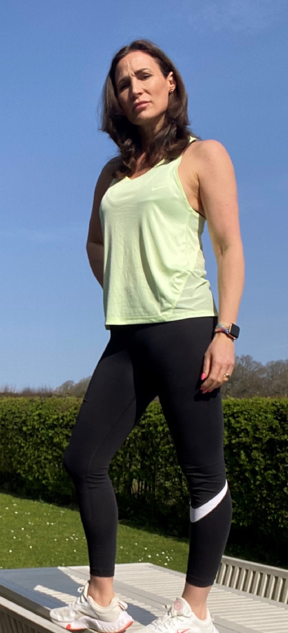 Woman posing and wearing a green top