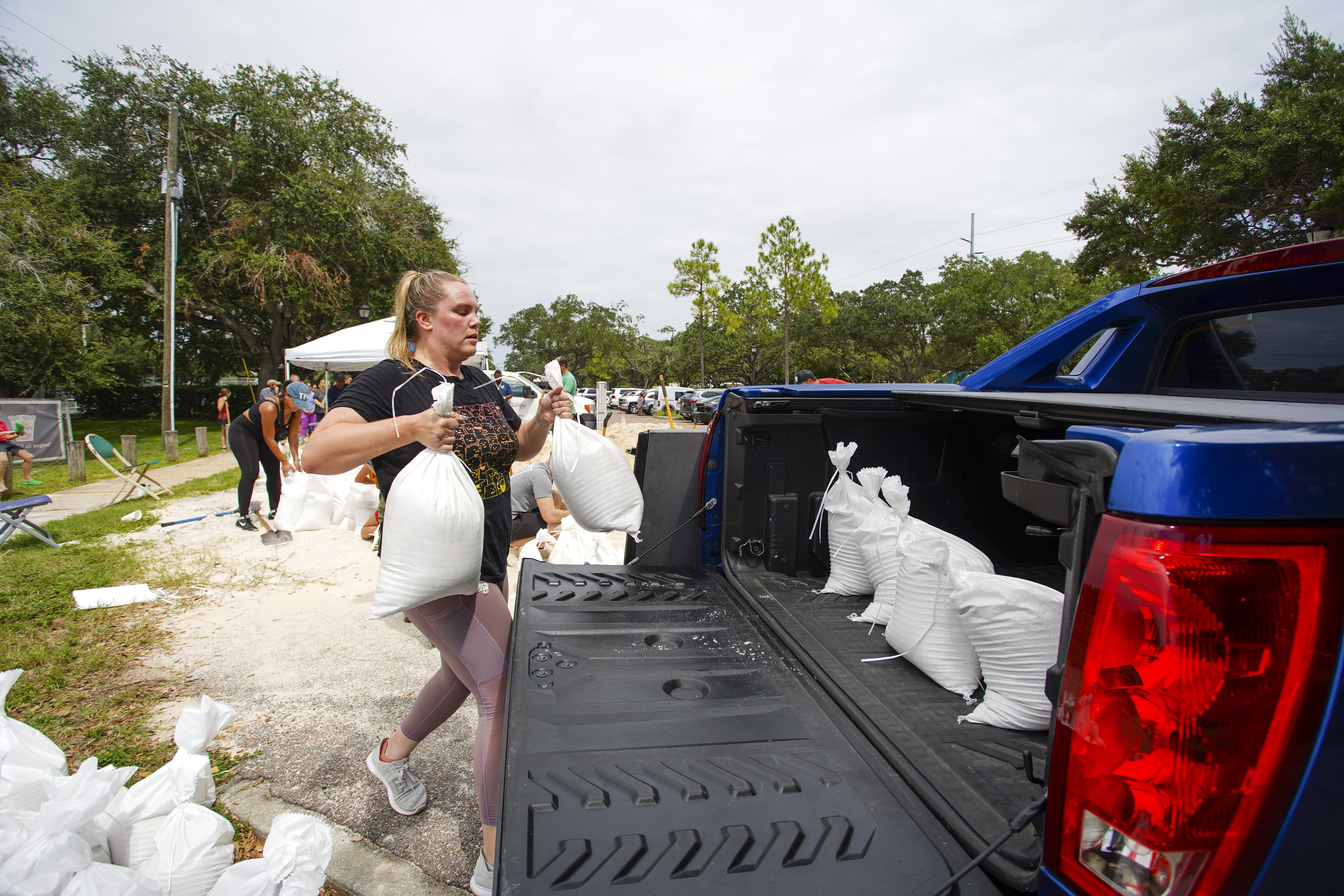 Victoria Colson, 31, of Tampa, loads sandbags into a truck