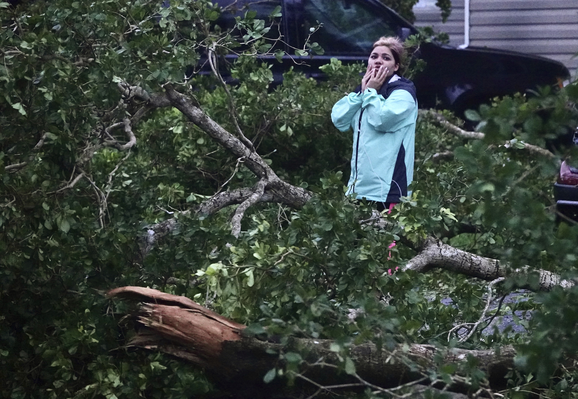 Zuram Rodriguez surveys the damage around her mobile home in Davie, Florida