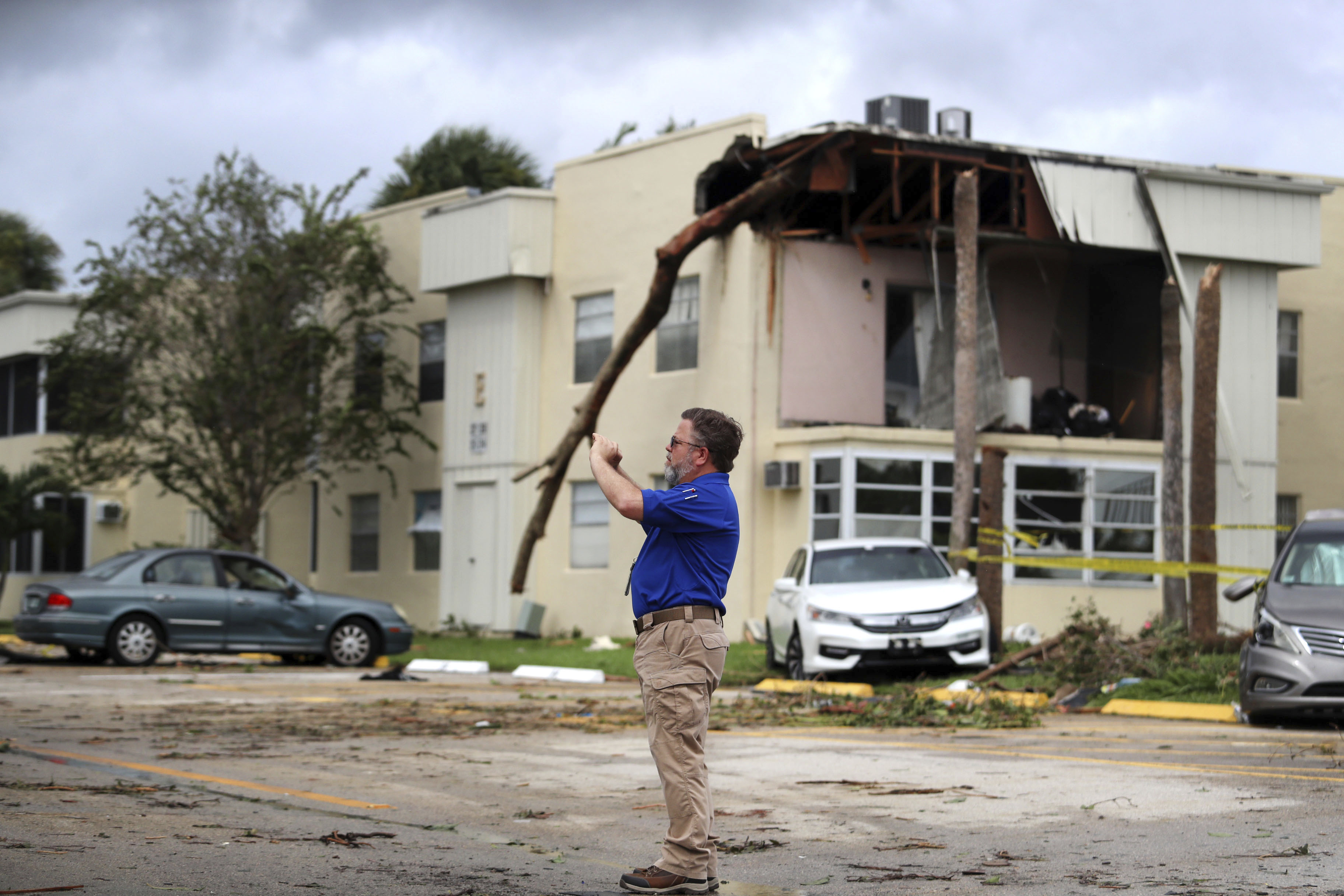 David Dellinger with the National Weather Service surveys the damage from an apparent overnight tornado spawned from Hurricane Ian at Kings Point 55+ community in Delray Beach, Florida