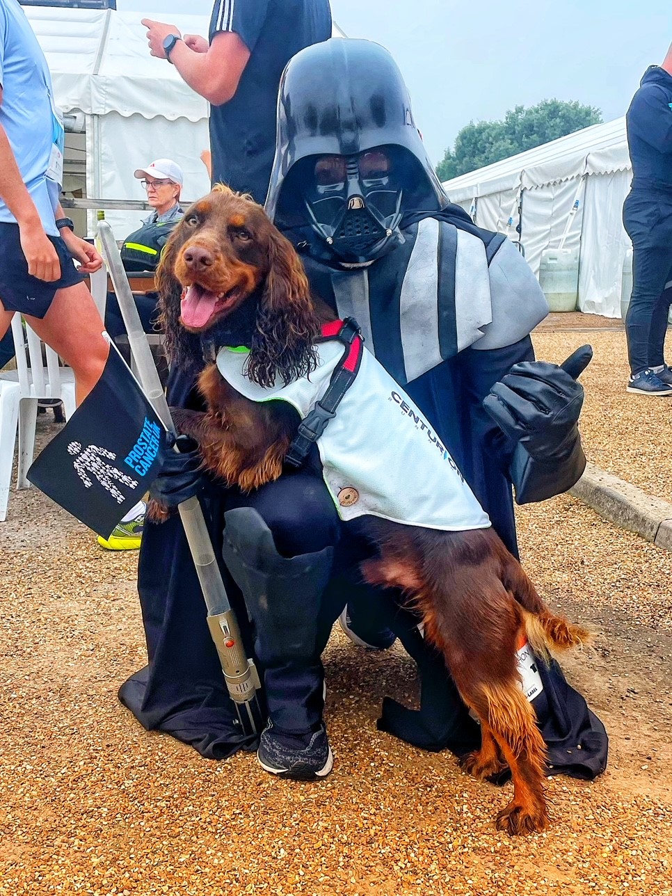Simon Best, dressed as Darth Vader, meets a dog at a previous fundraising run