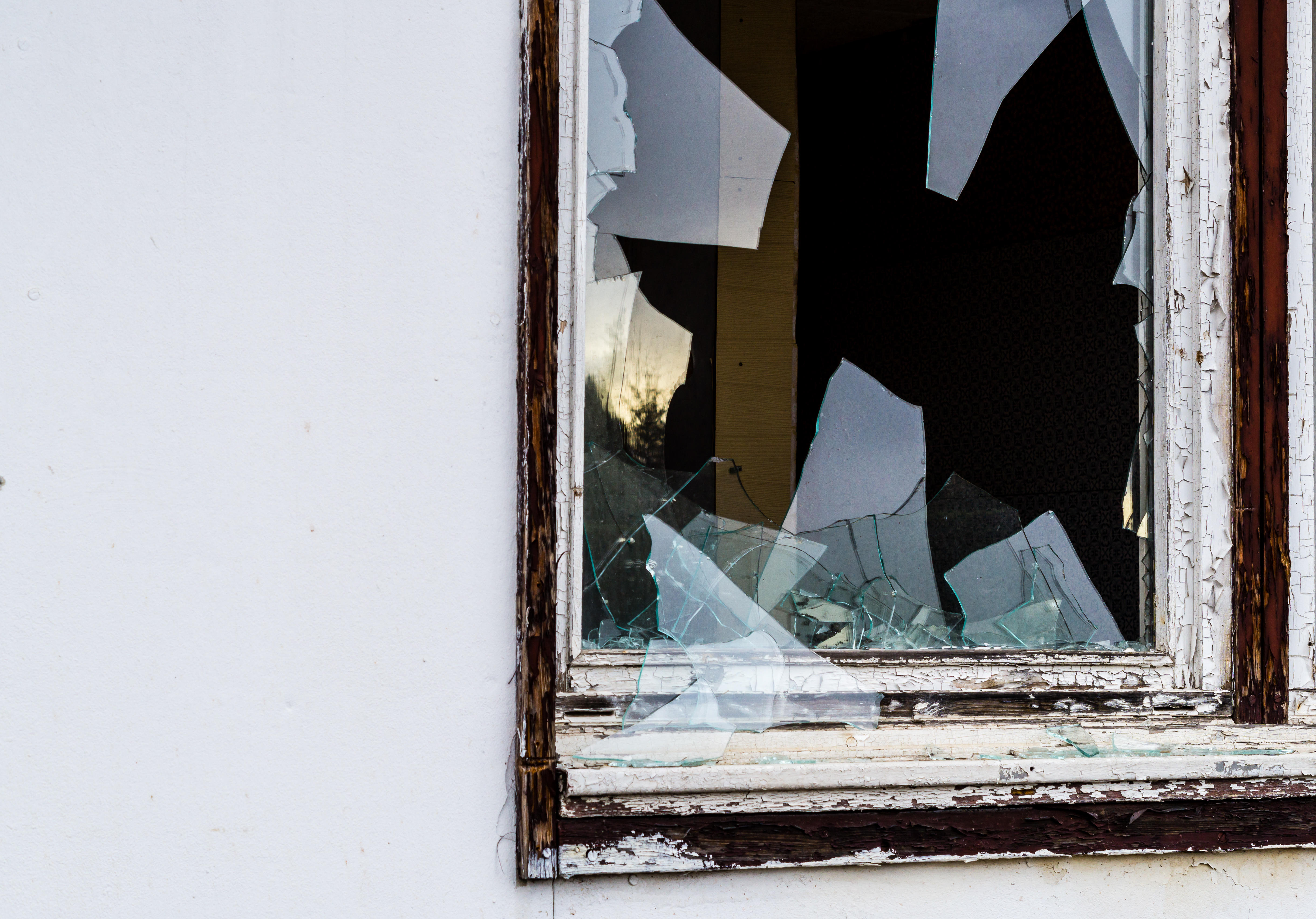Smashed house window after burglary