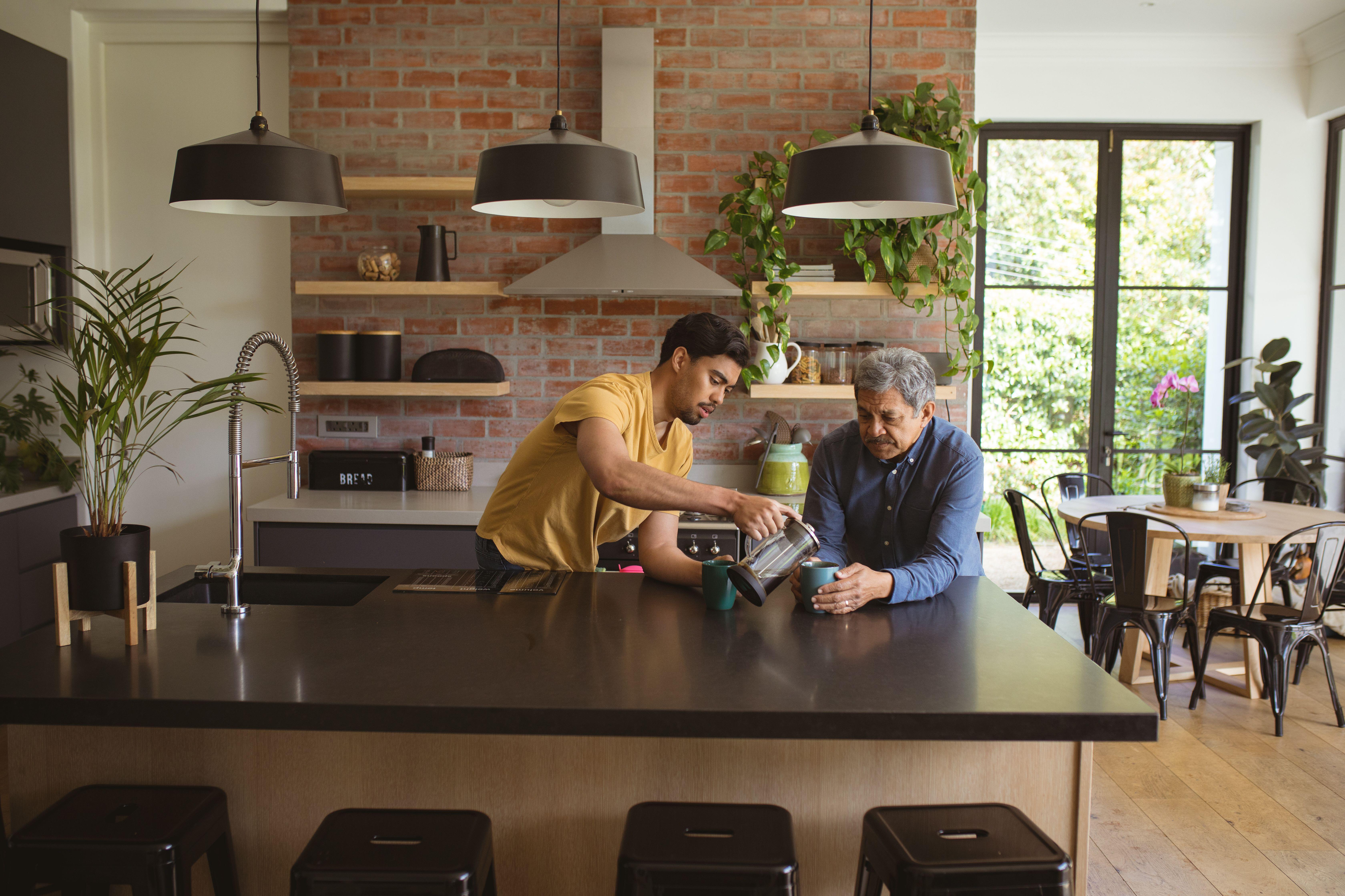 Father and son drinking coffee in a kitchen