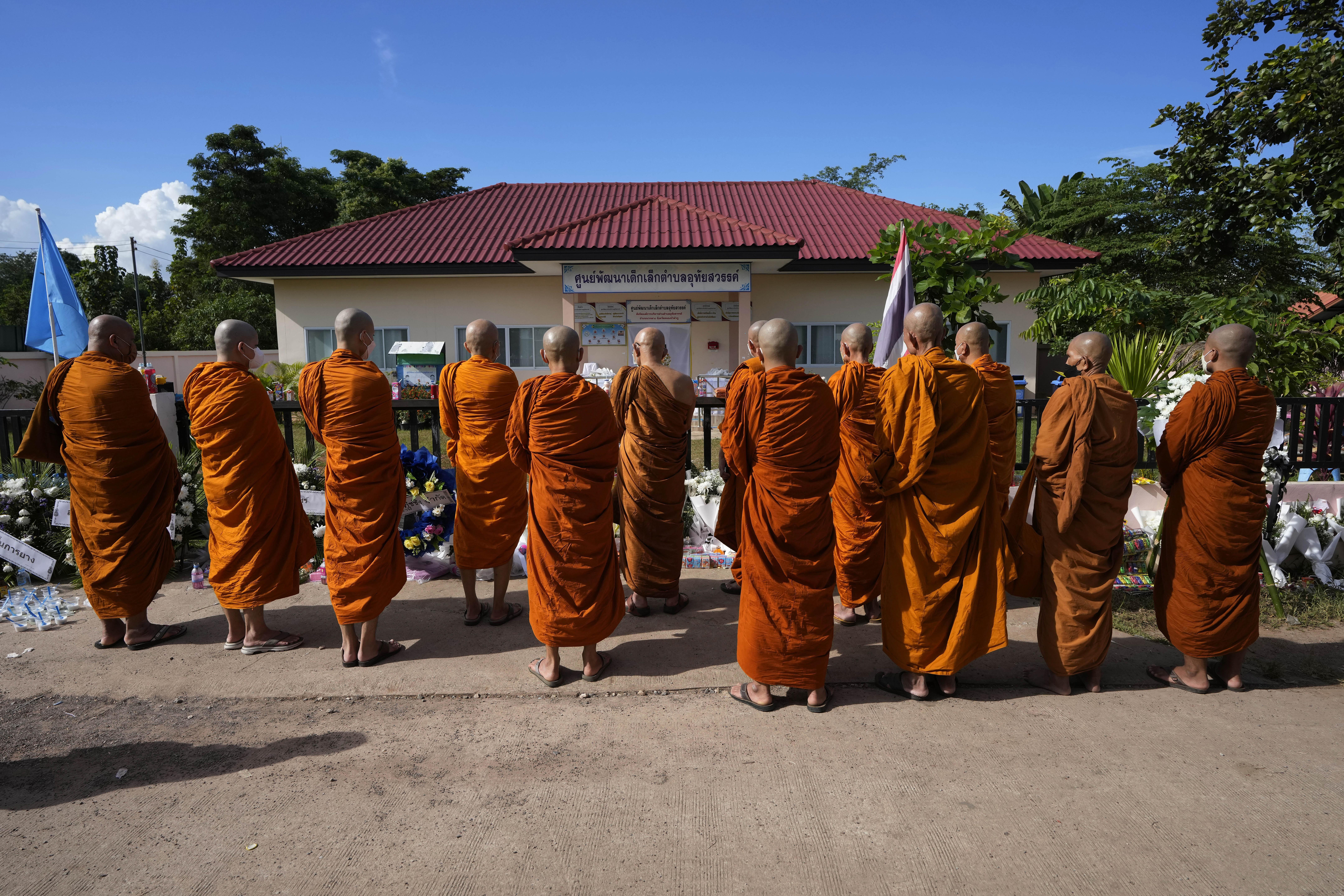 Buddhist monks pray for the victims of the mass killing 