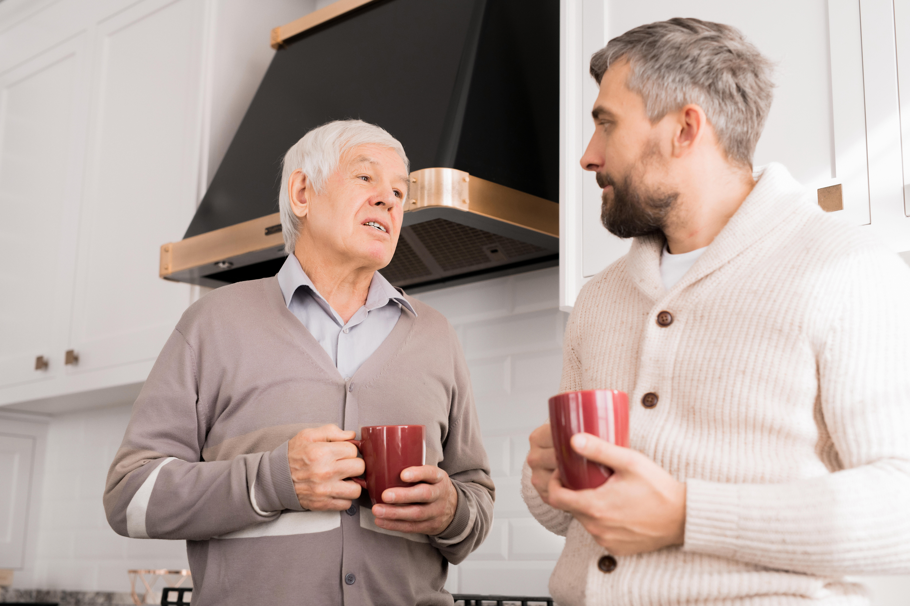 father and son talking and drinking coffee