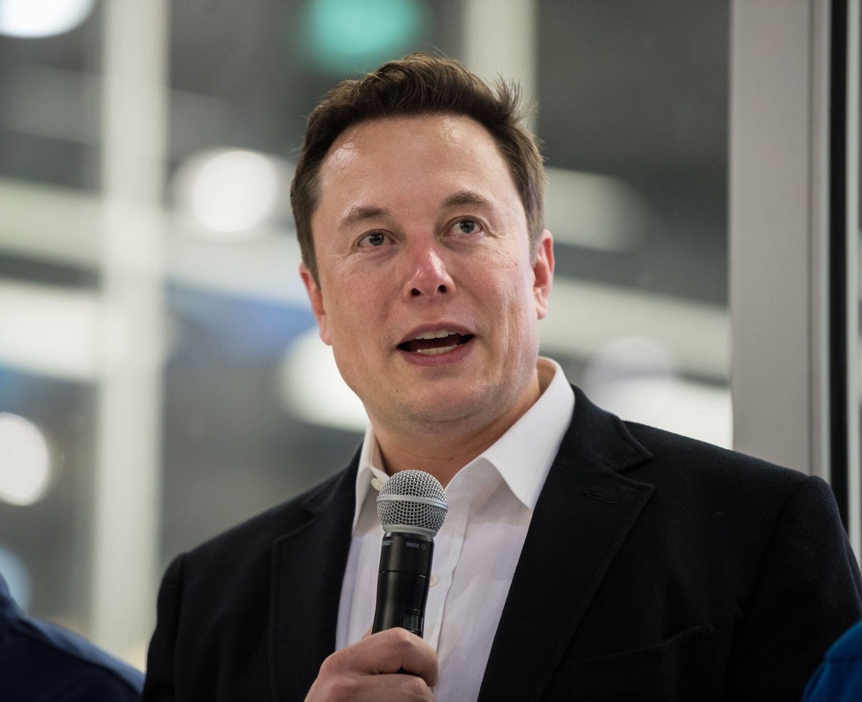 Elon Musk speaks into microphone