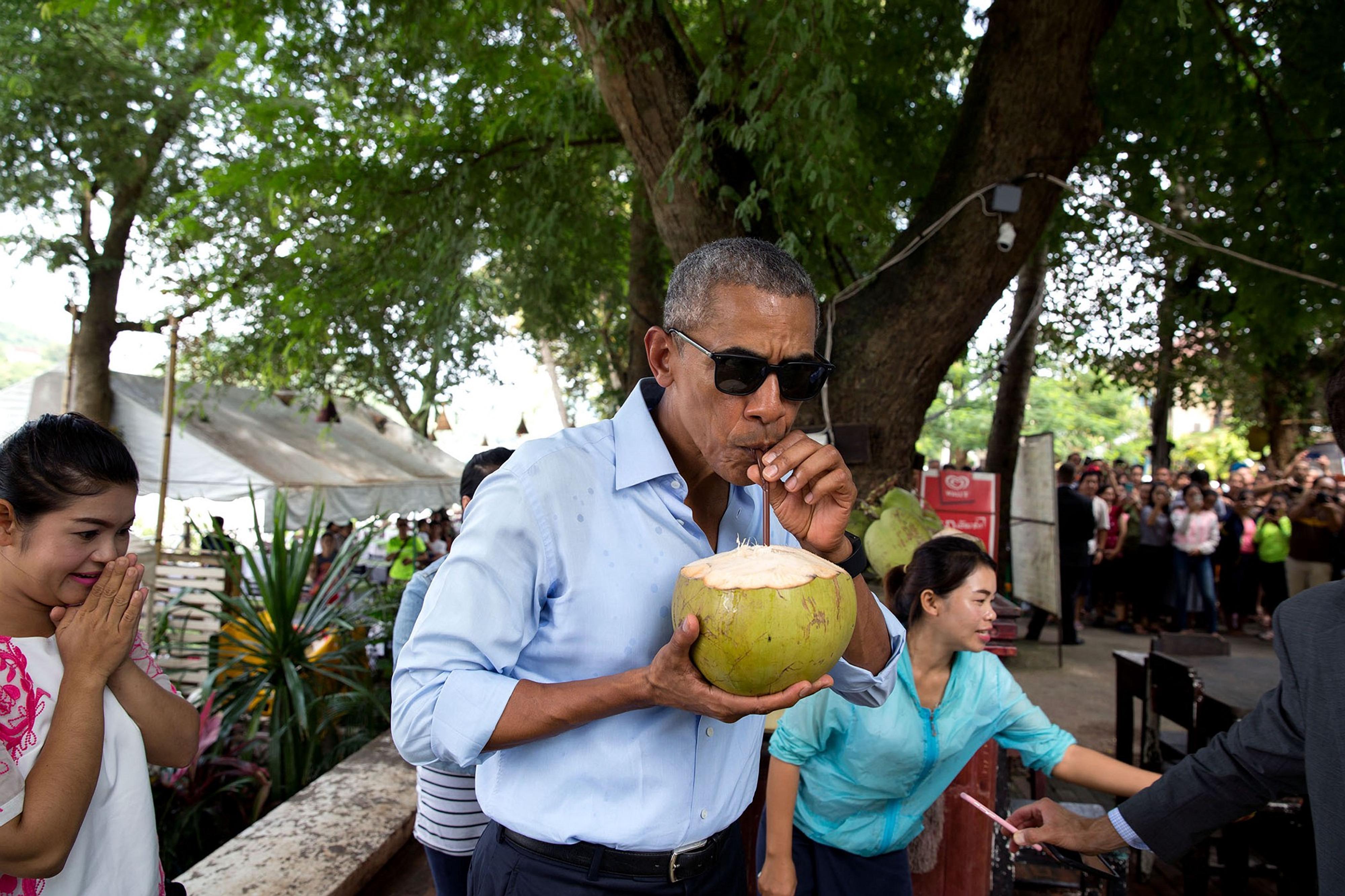 Barack Obama sips from a coconut in Laos in 2016. Bono said the 44th president of the US says he drank him under the table