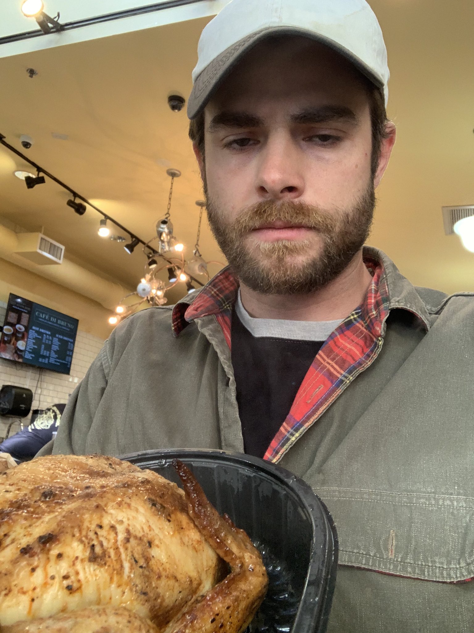 Man holding a chicken in his hand