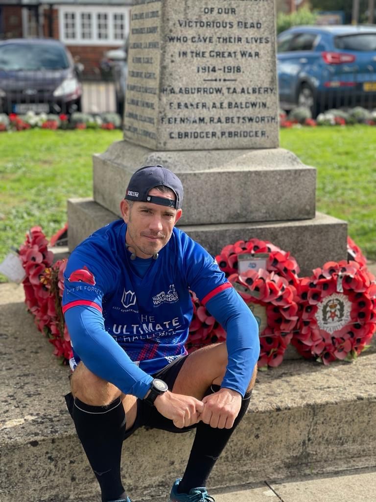 Brian Wood sat next to a war memorial.