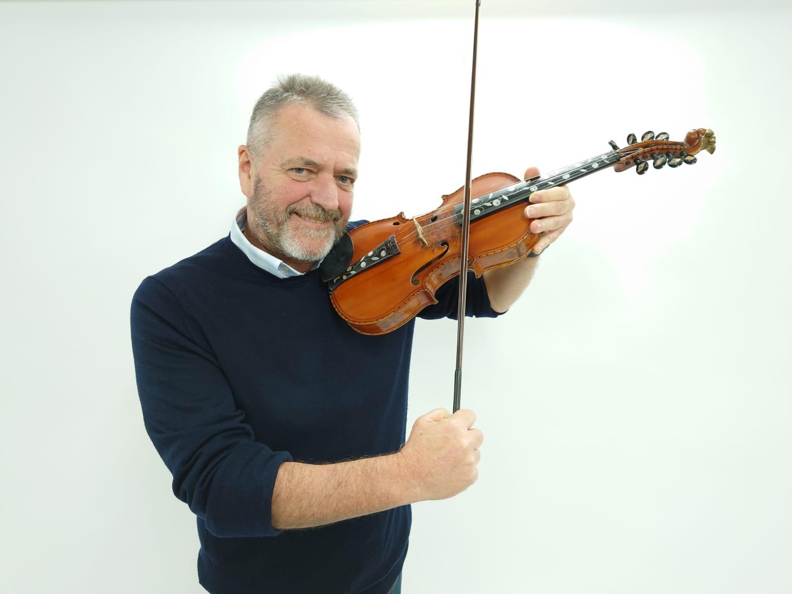 Auctioneer Jamie South with the Lord of the Rings Hardanger violin (Gardiner Houlgate/PA)