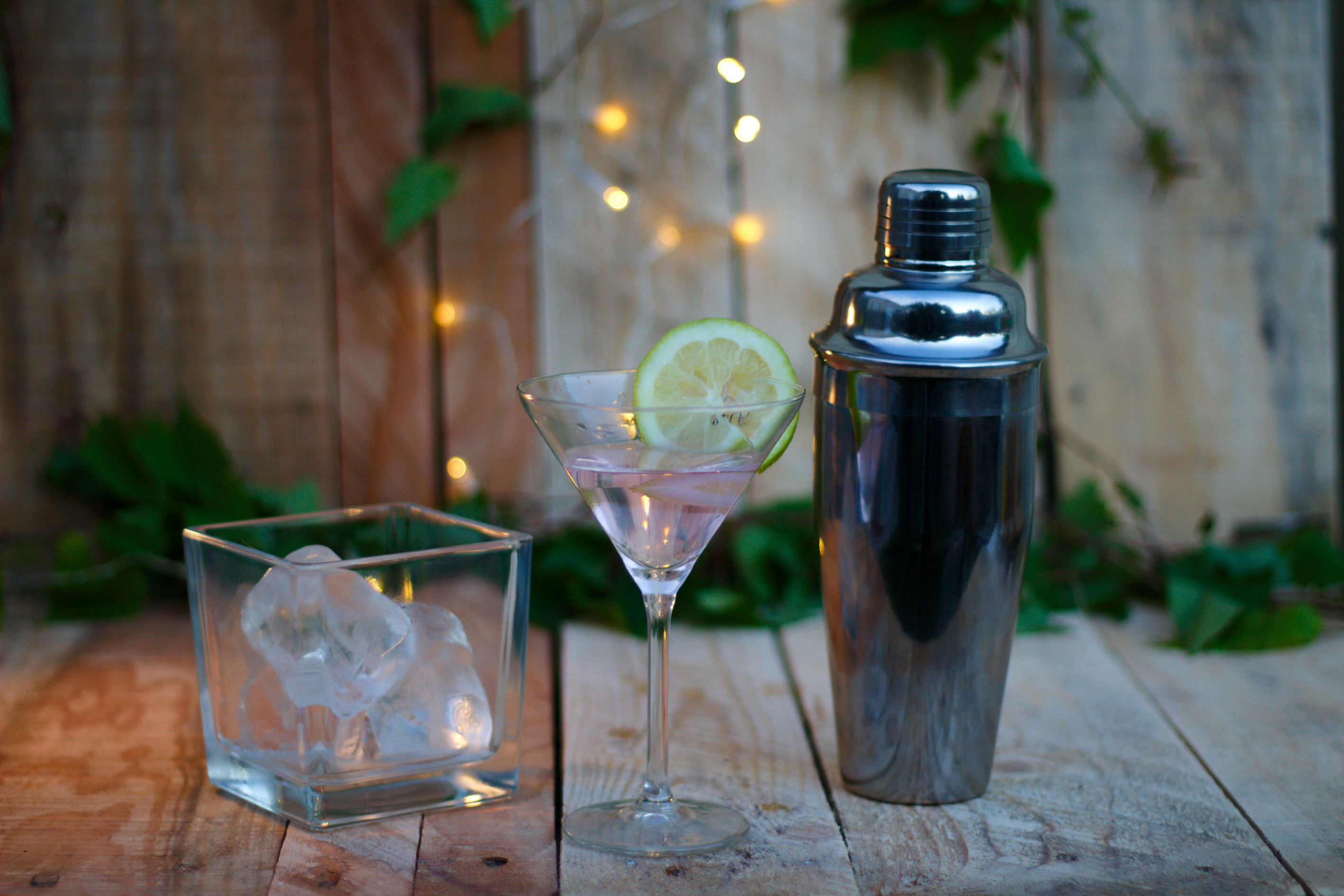 Cocktail shaker with ice and lemon