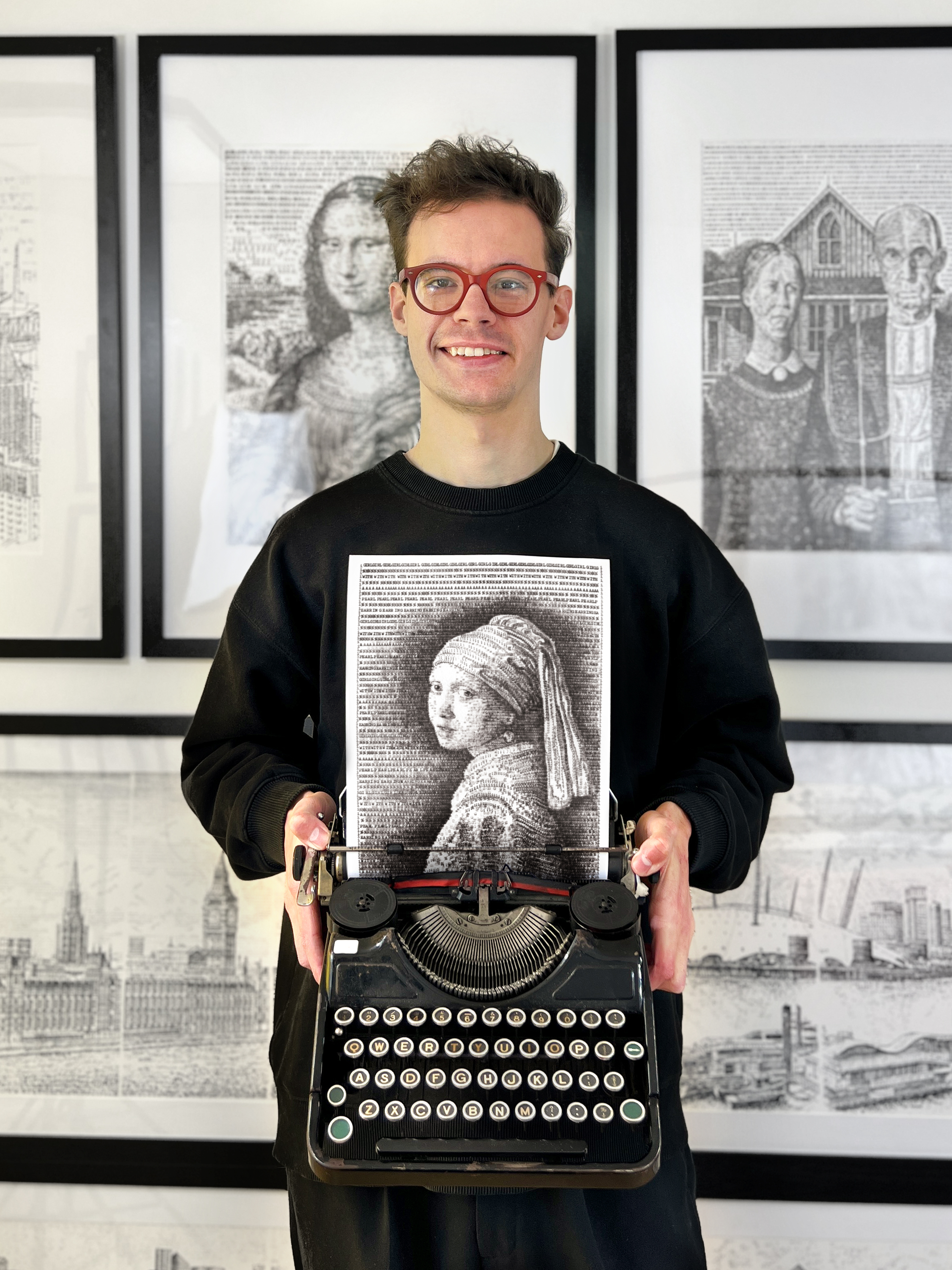 Man smiling with a typewriter in his hand