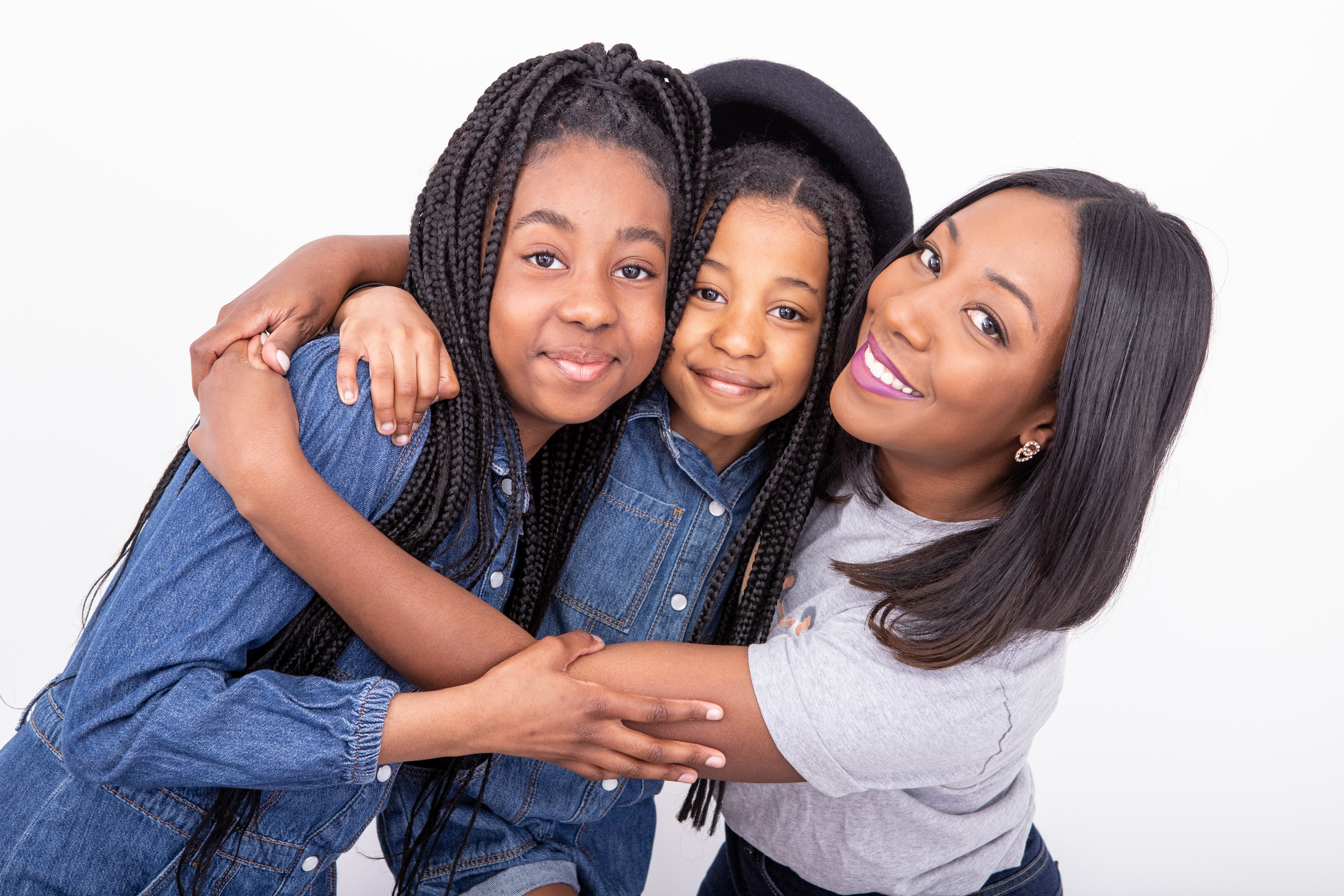 Three females standing next to each other and hugging