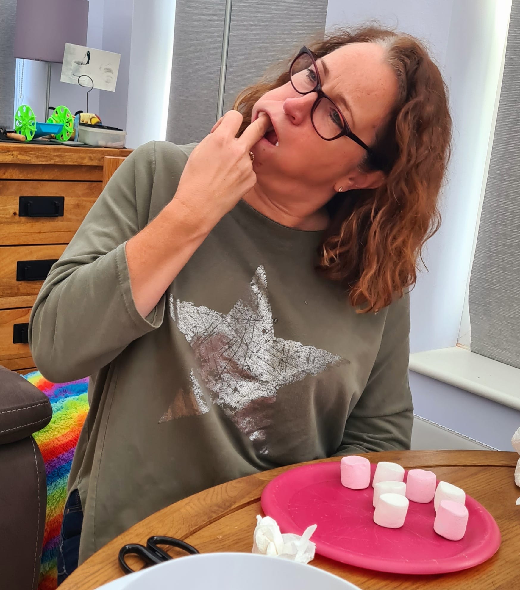 Woman shoving marshmallows into her mouth