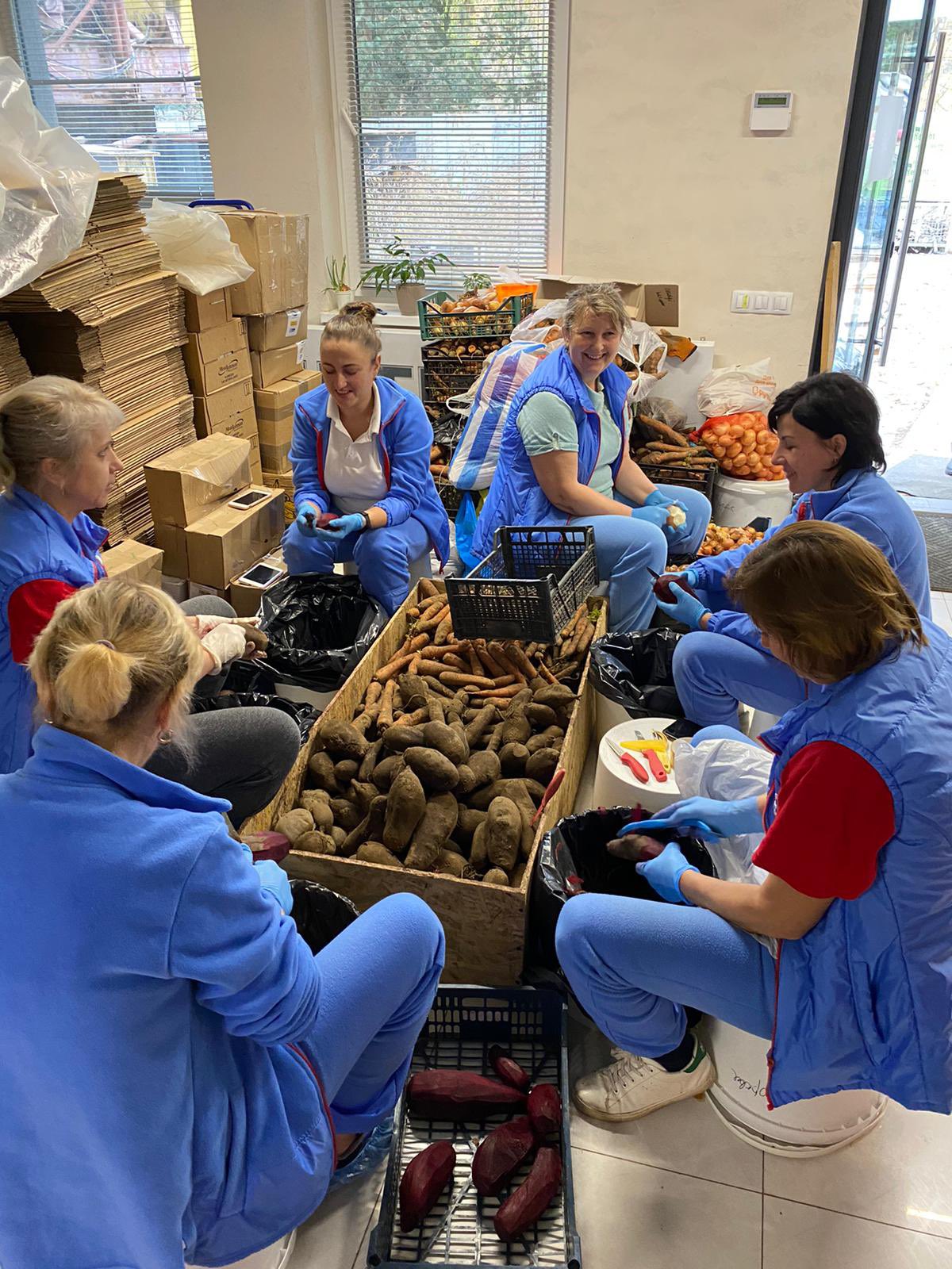 Women peeling vegetables