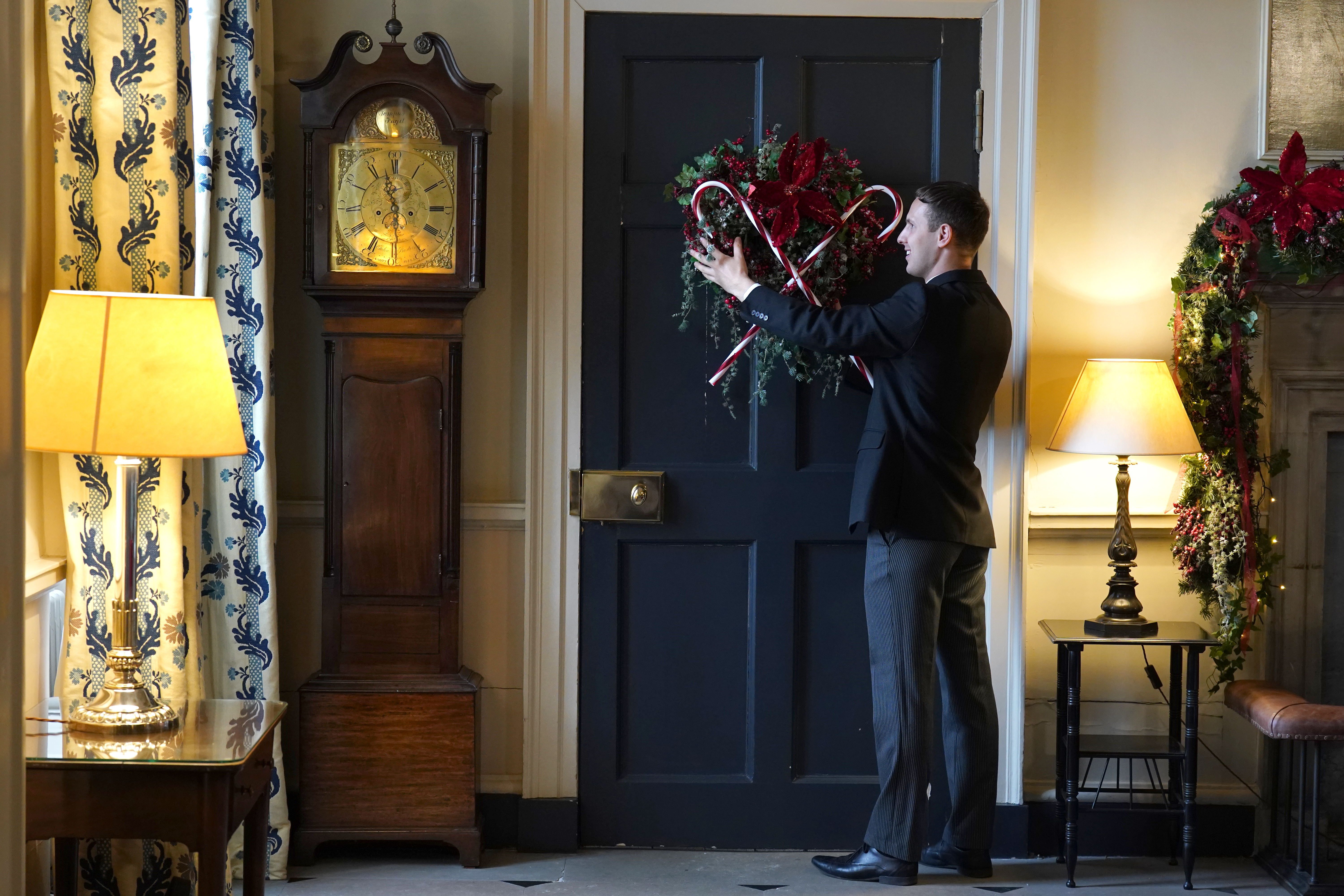 Michael Russell checks the candy cane decorations on the door