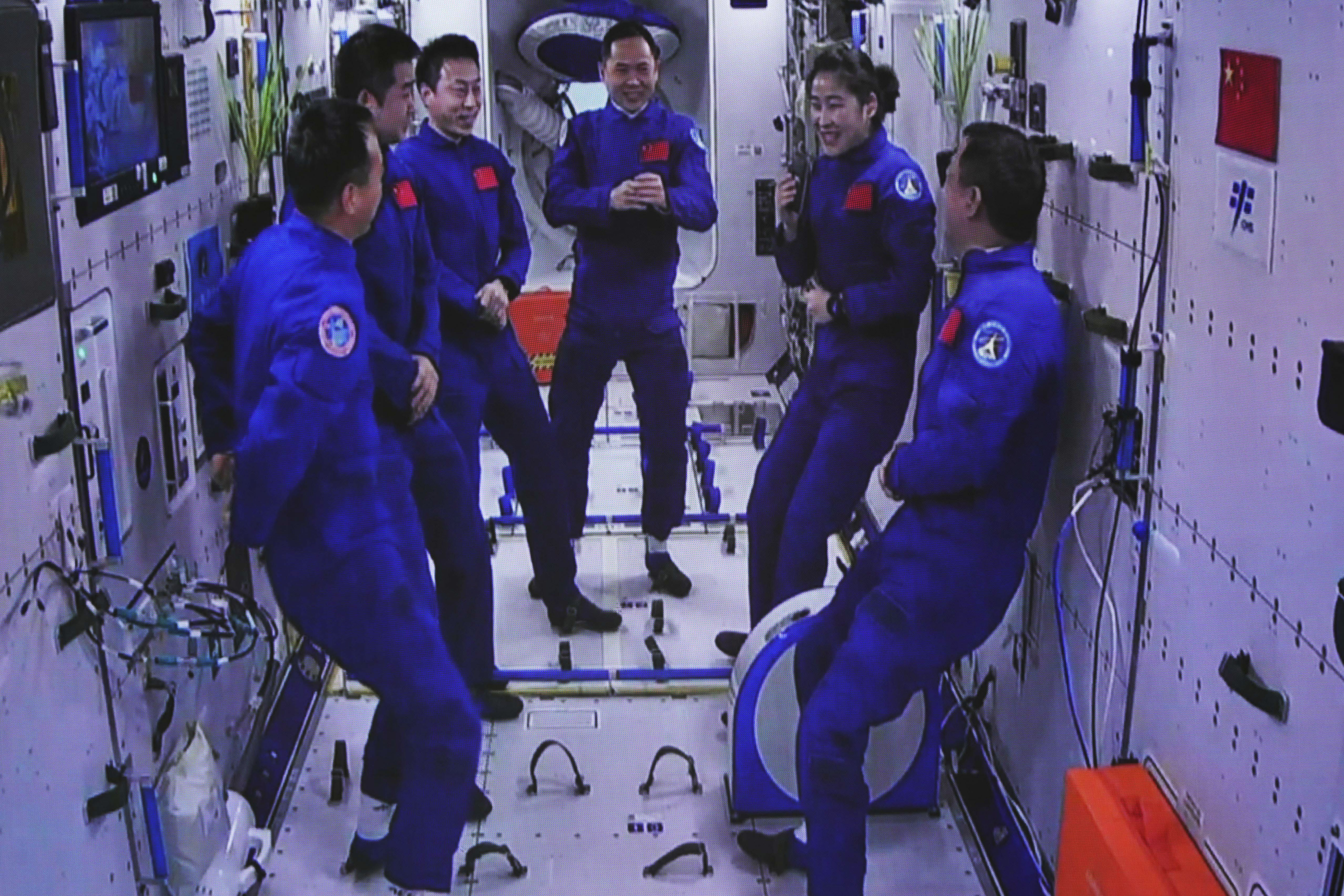 The Shenzhou-15 and Shenzhou-14 crew chatting after a historic gathering in space
