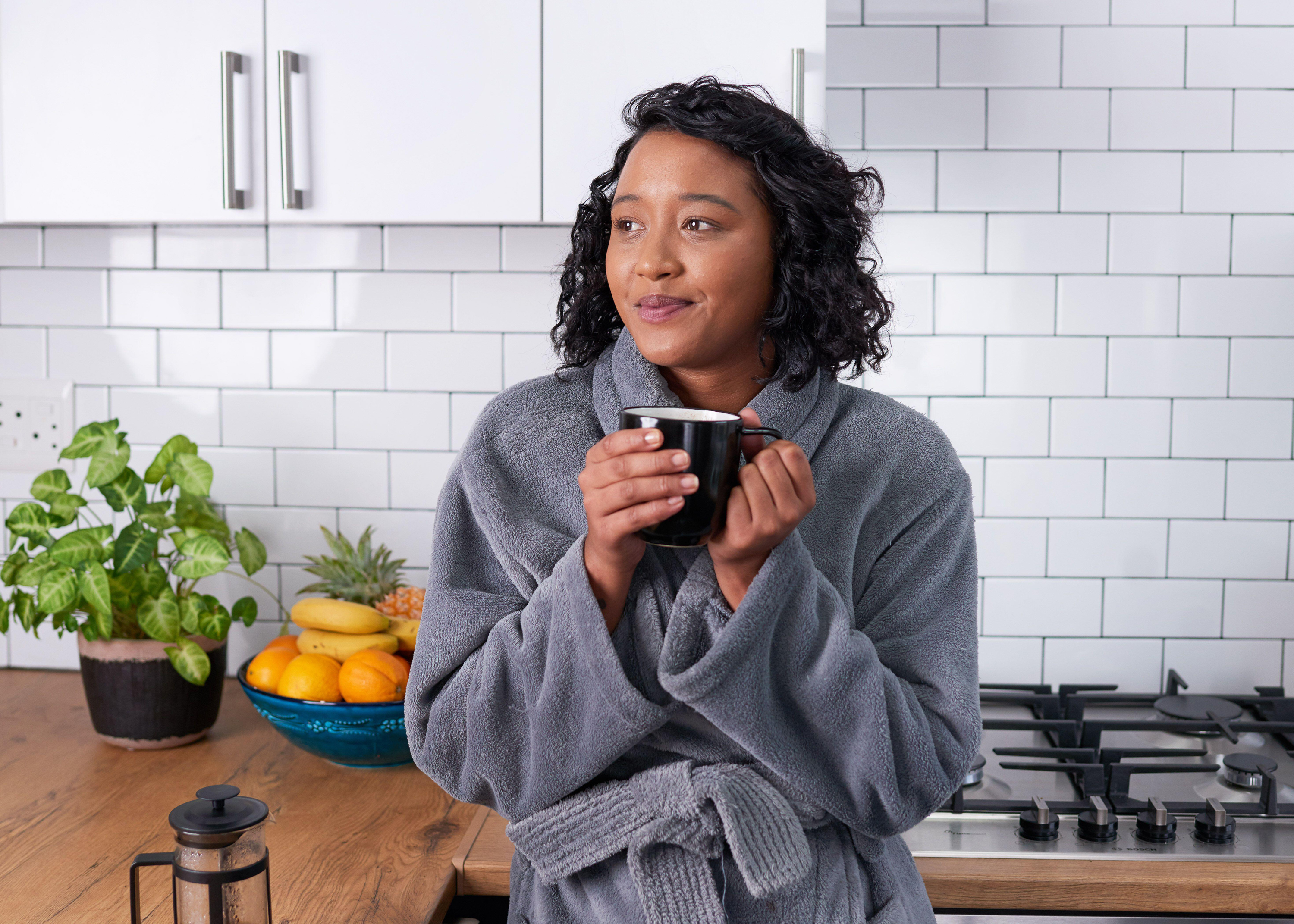 woman wearing dressing gown in kitchen