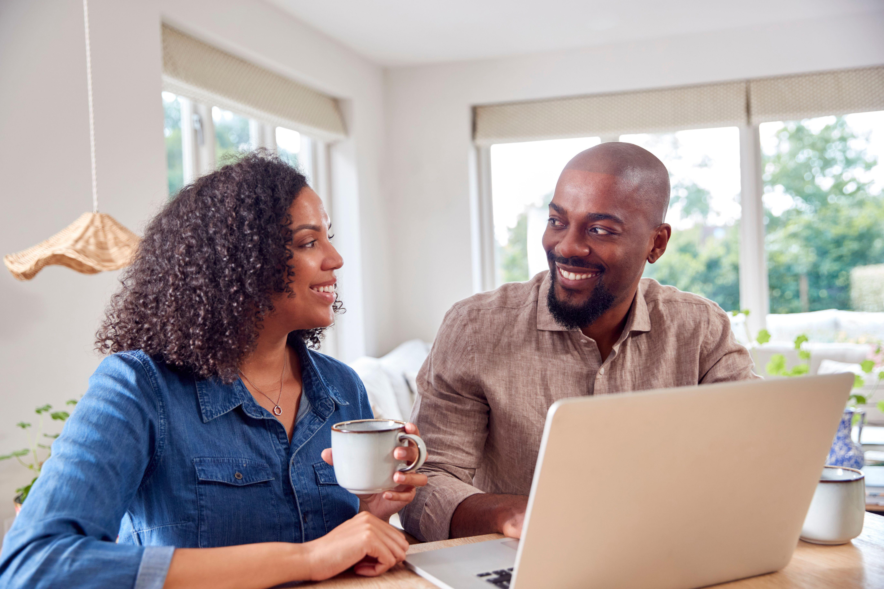 couple booking holiday on laptop