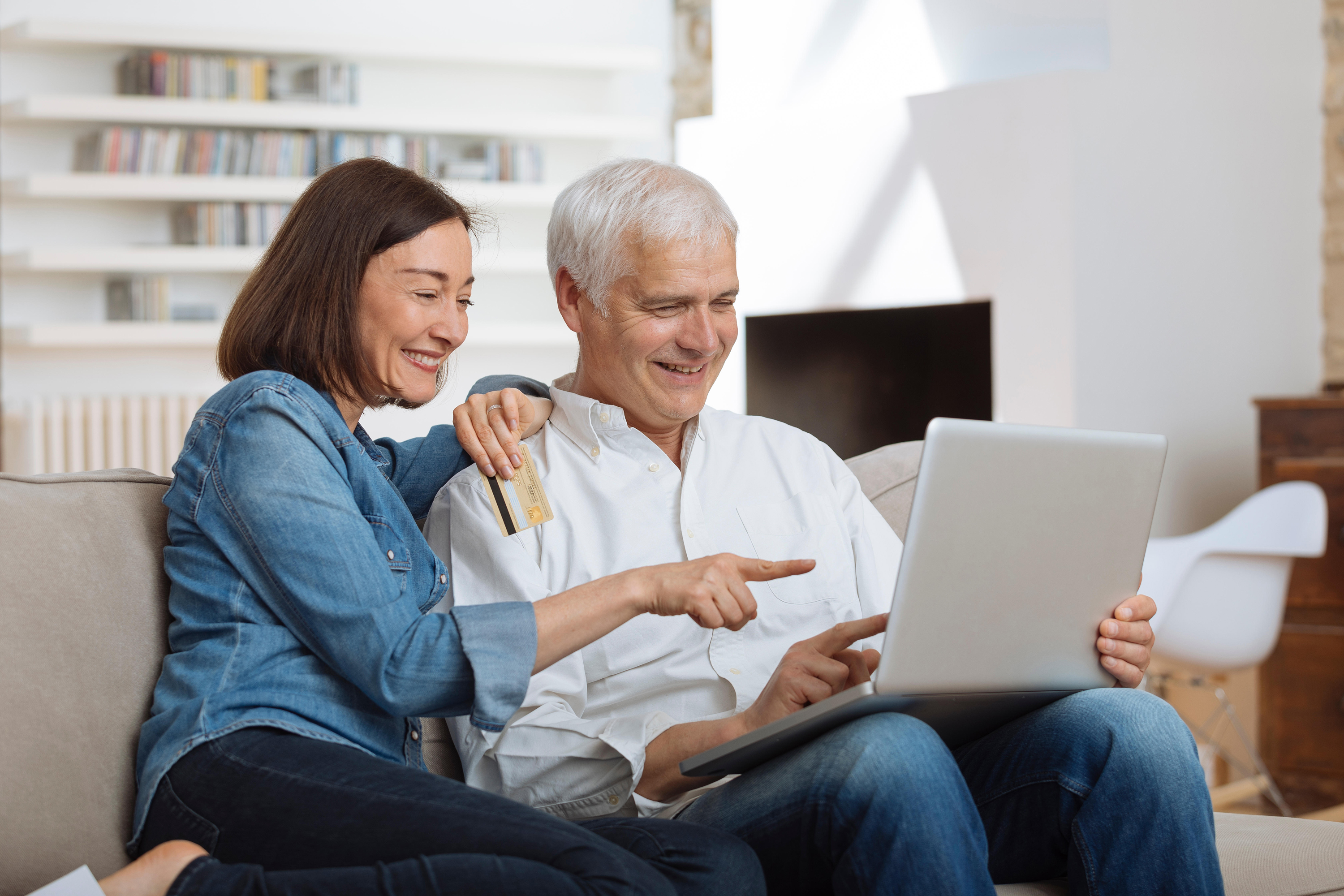 couple booking holiday on laptop