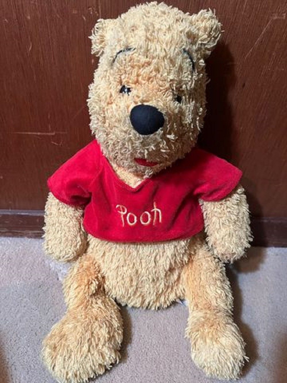 Stuffed yellow bear, wearing a red top