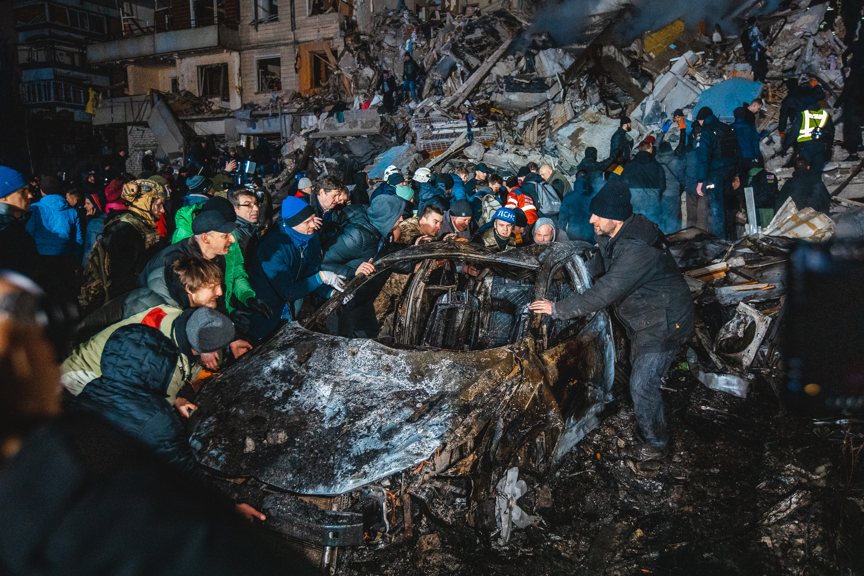 Civilians trying to move scorched car