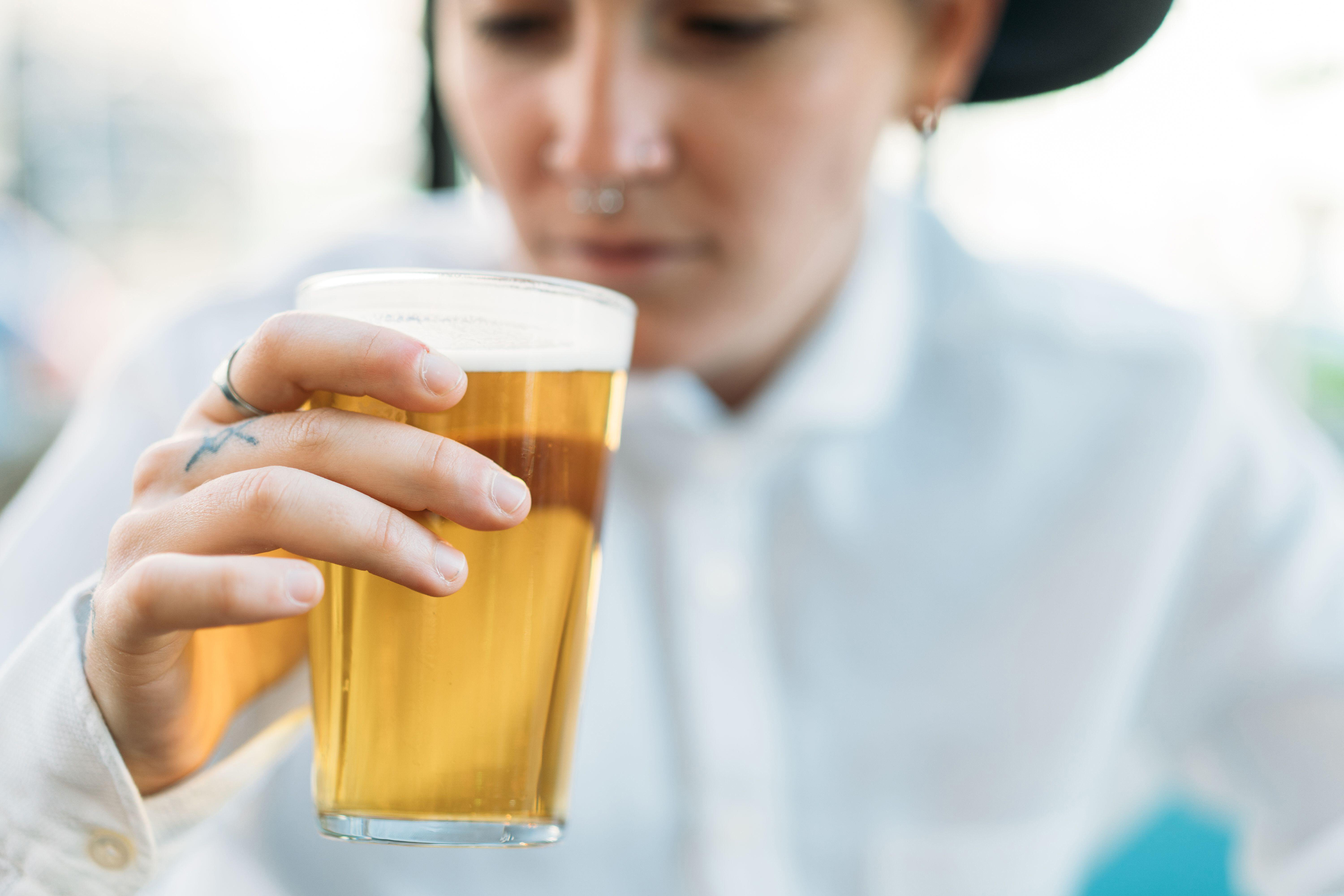 woman drinking pint of beer