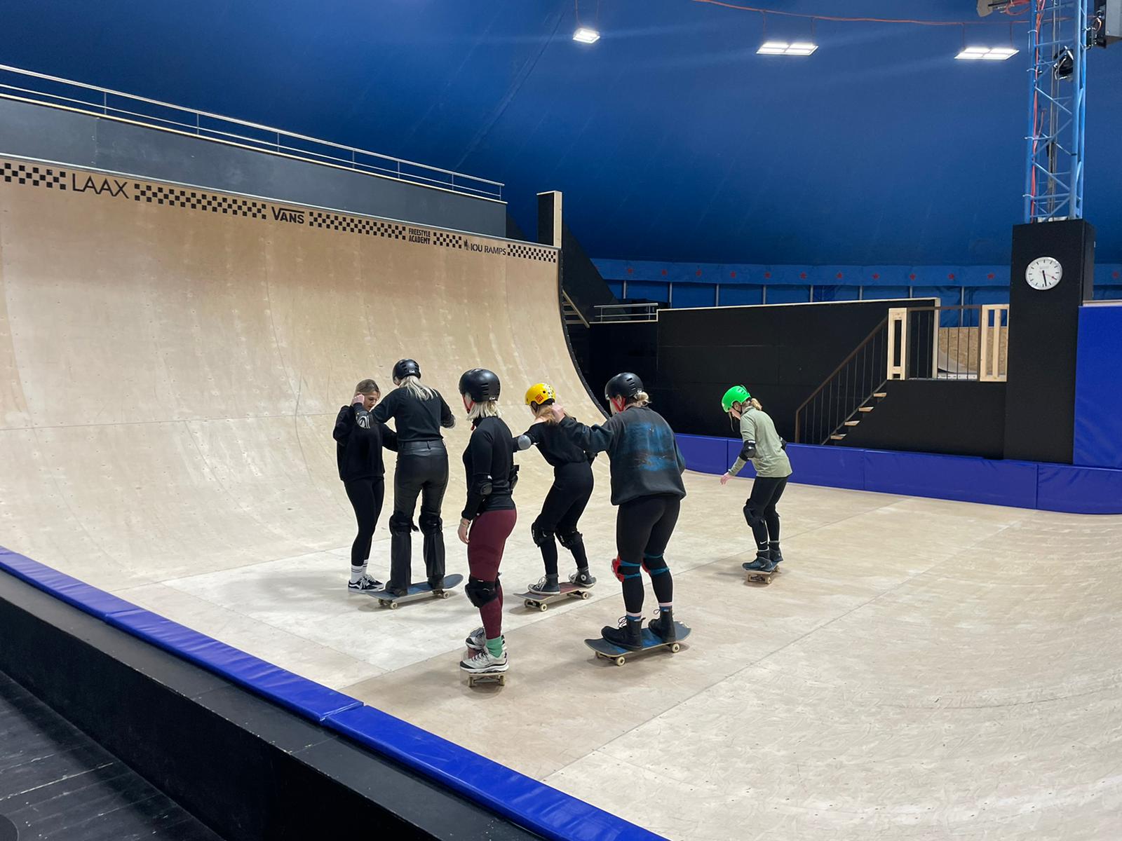 group of journalists learning to skateboard