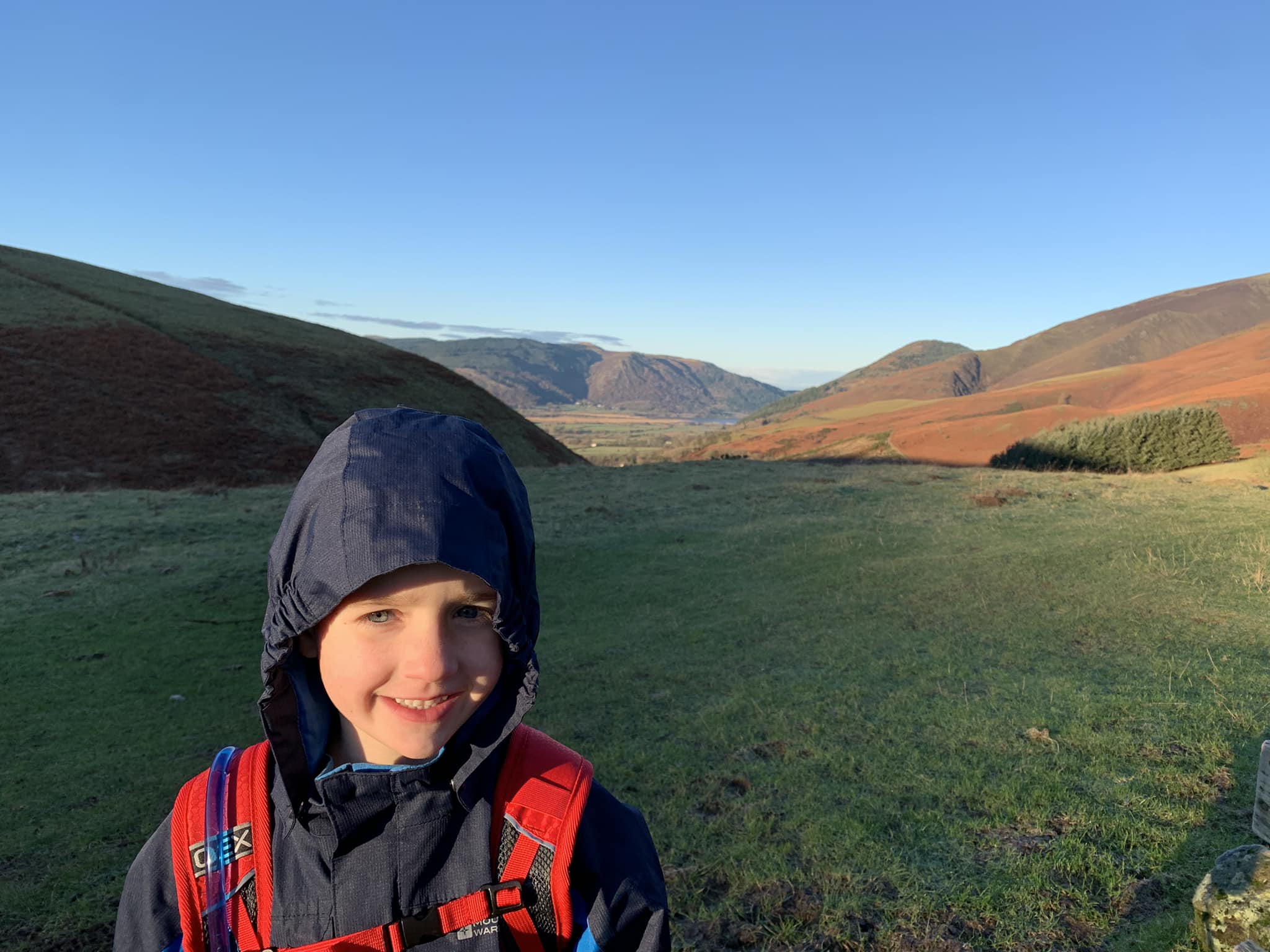 Boy wearing a rain jacket and rucksack