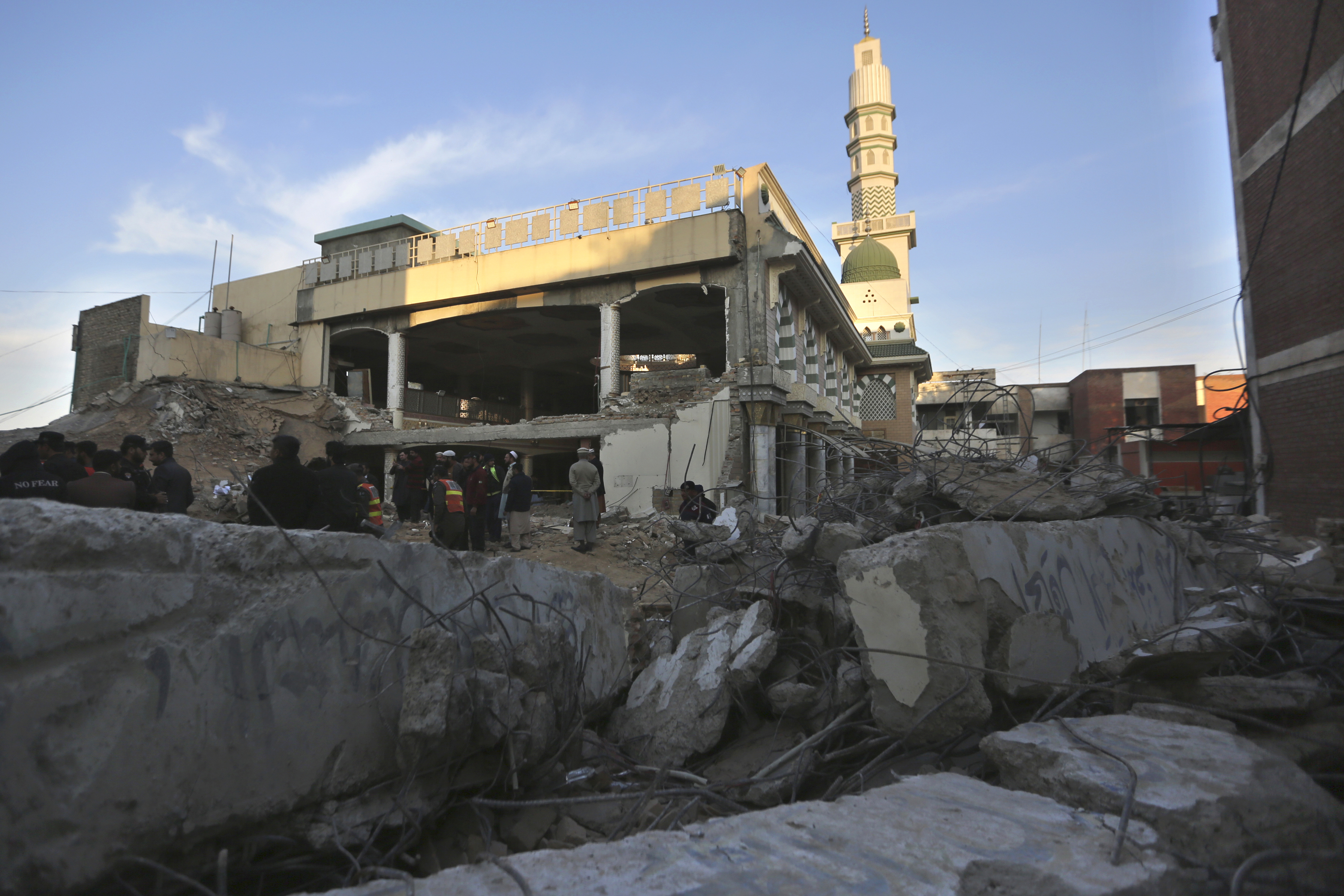 Rescue workers and people gather at the site of Monday's suicide bombing