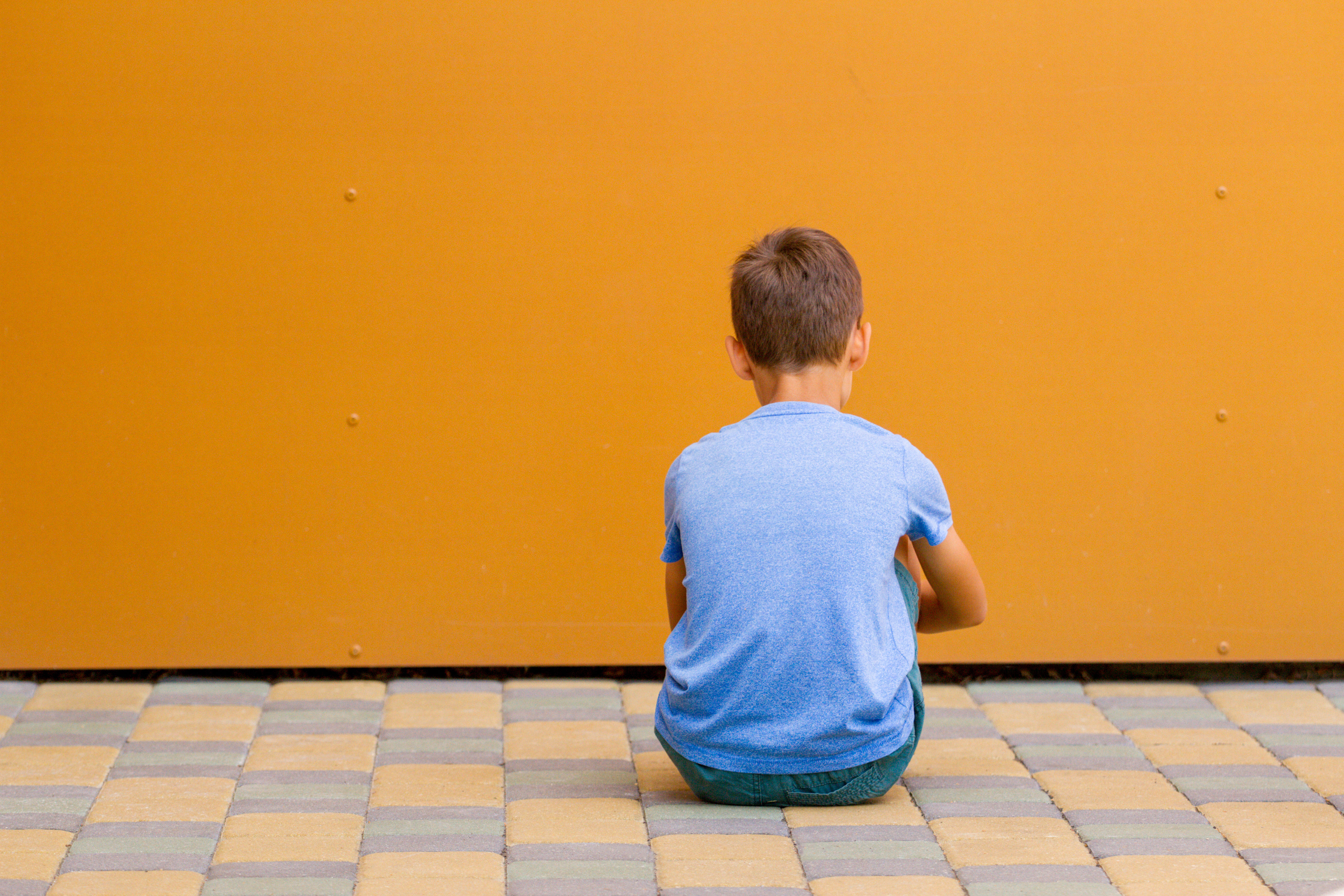 Boy sitting alone