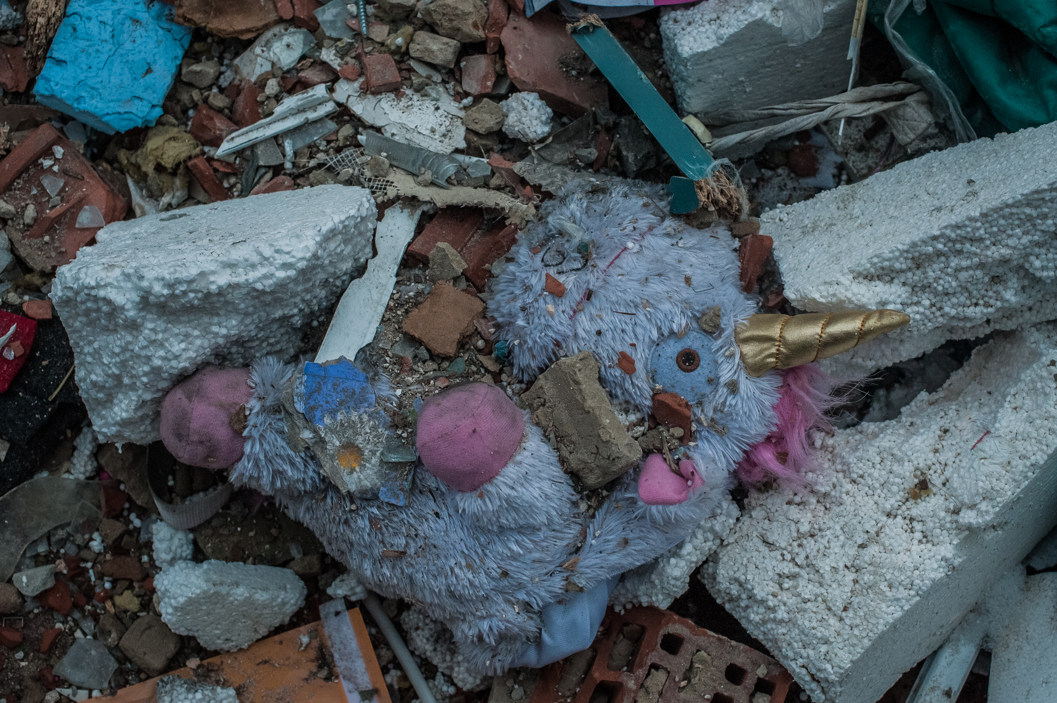 Unicorn toy in rubble