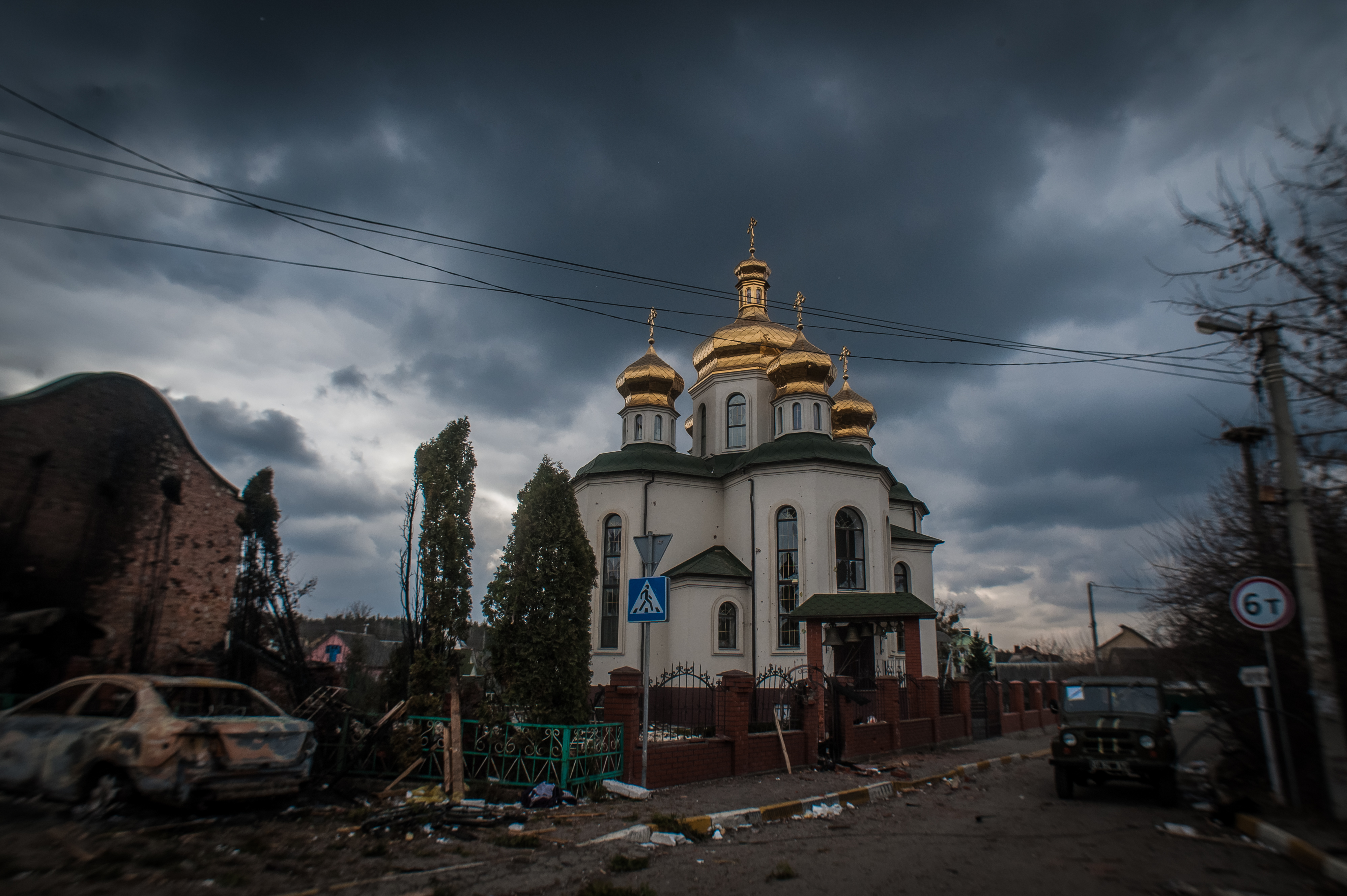 Cloudy sky above a building with a gold roof