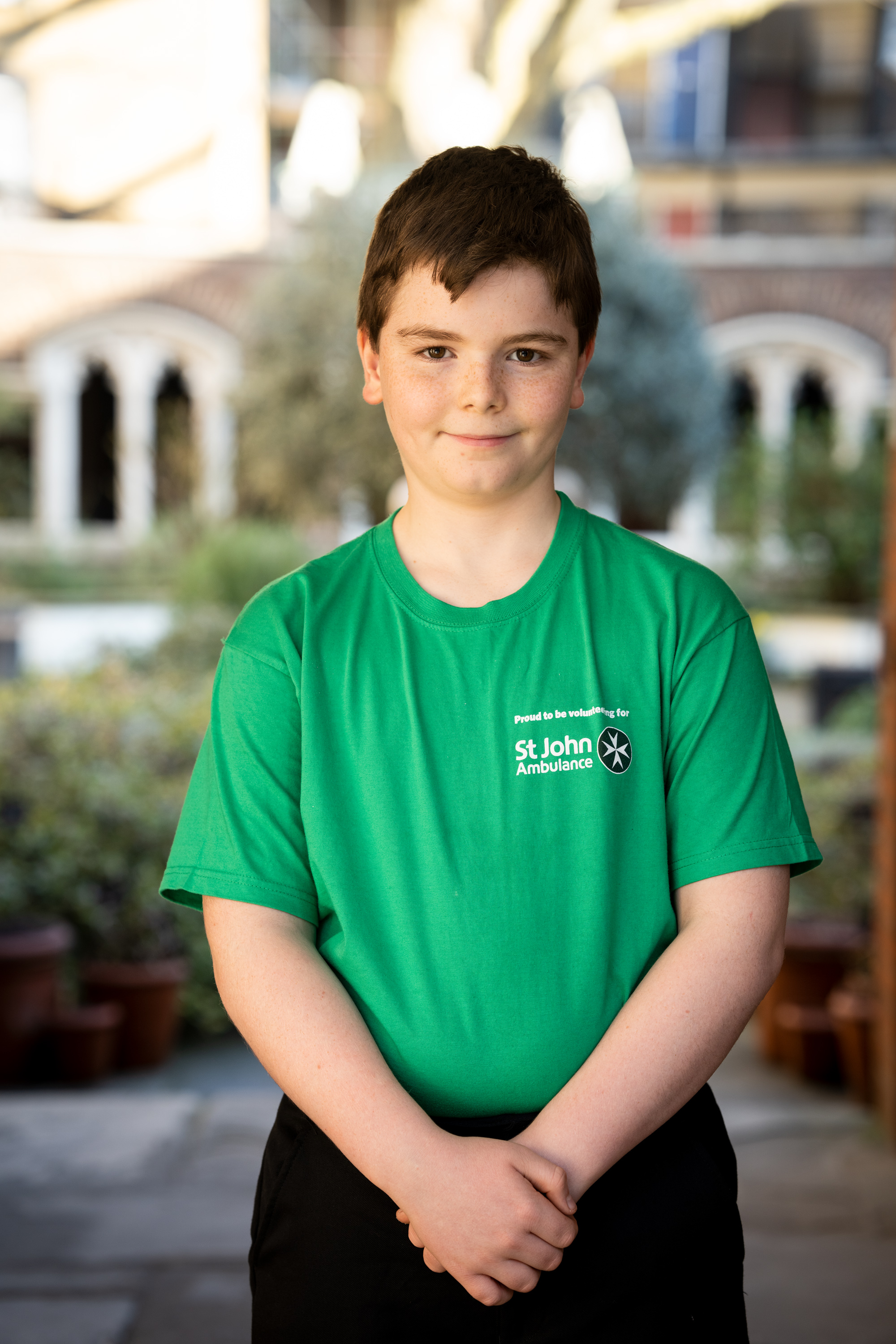 Boy wearing a green top and looking at the camera
