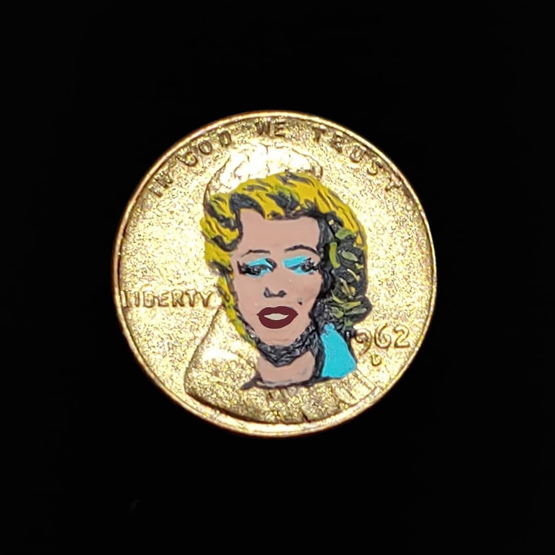Gold coin with Marilyn Monroe painted on it