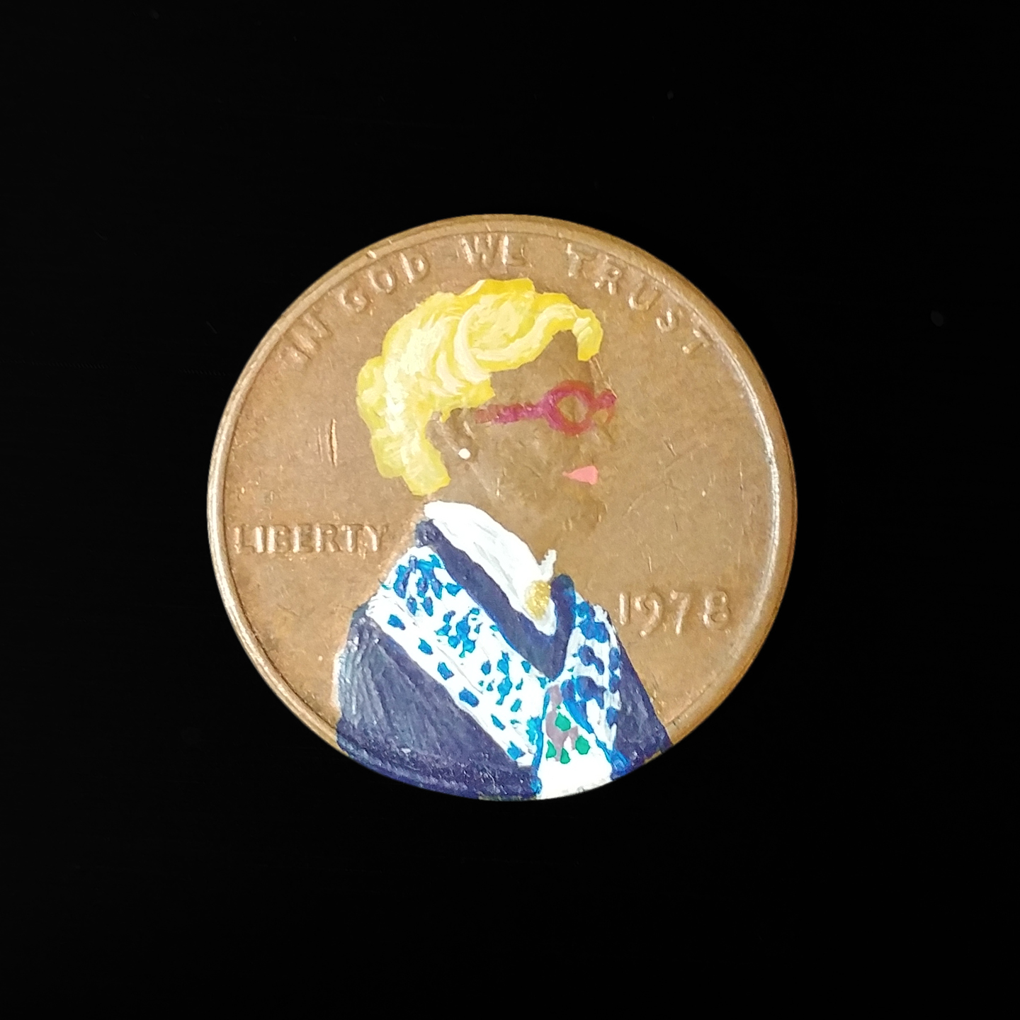 Woman with a blue jumper painted on a penny