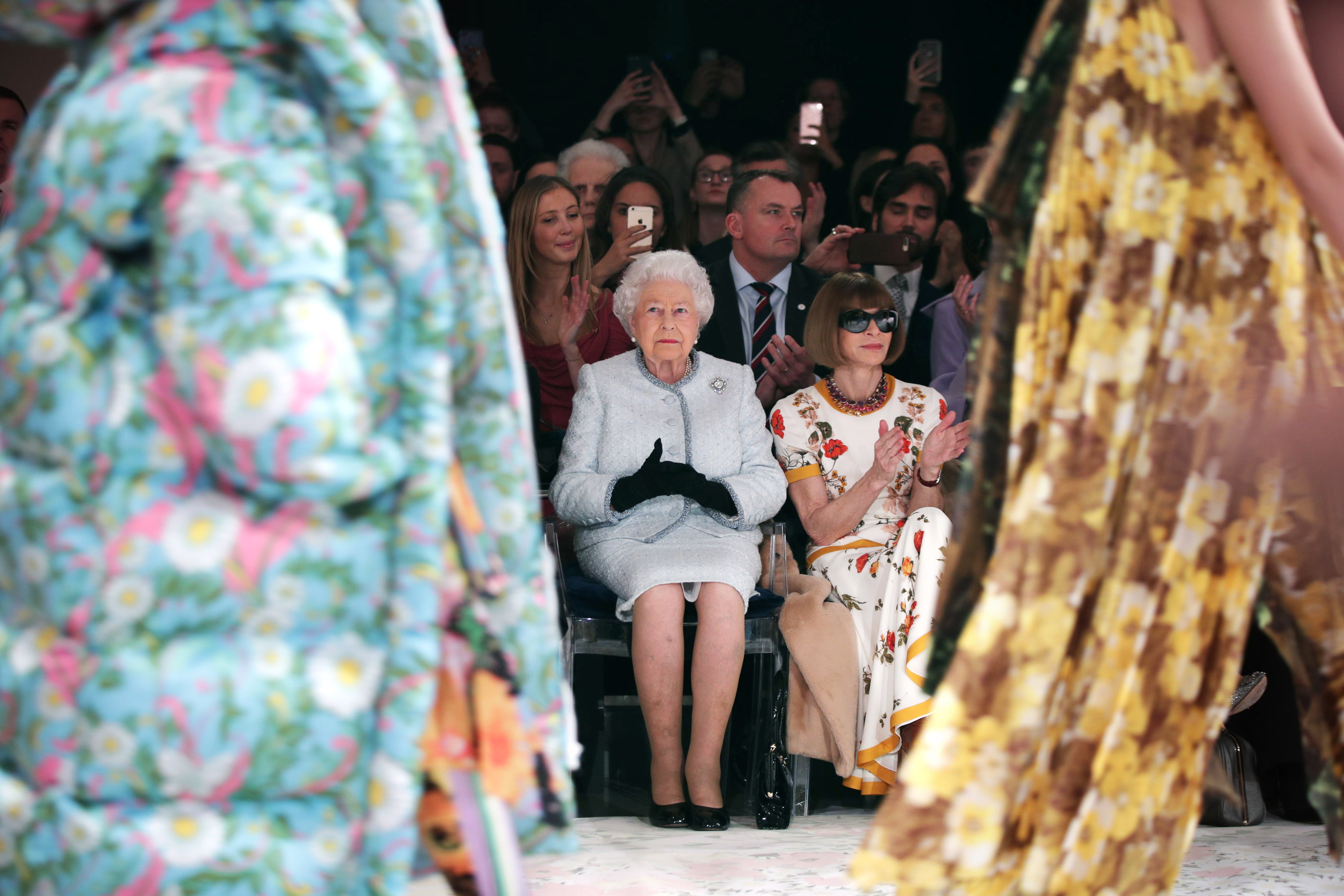 Queen Elizabeth II sitting next to Anna Wintour (right) at Quinn's show in 2018 