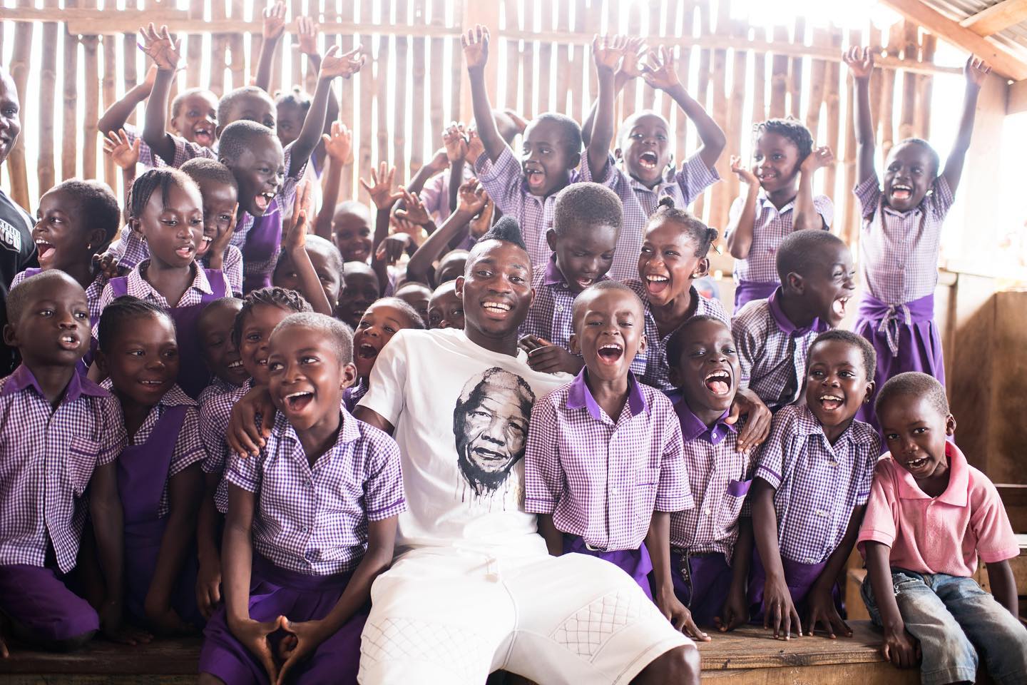 Arms Around The Child ambassador Christian Atsu with children in Ghana (Arms Around the Child/PA handout).