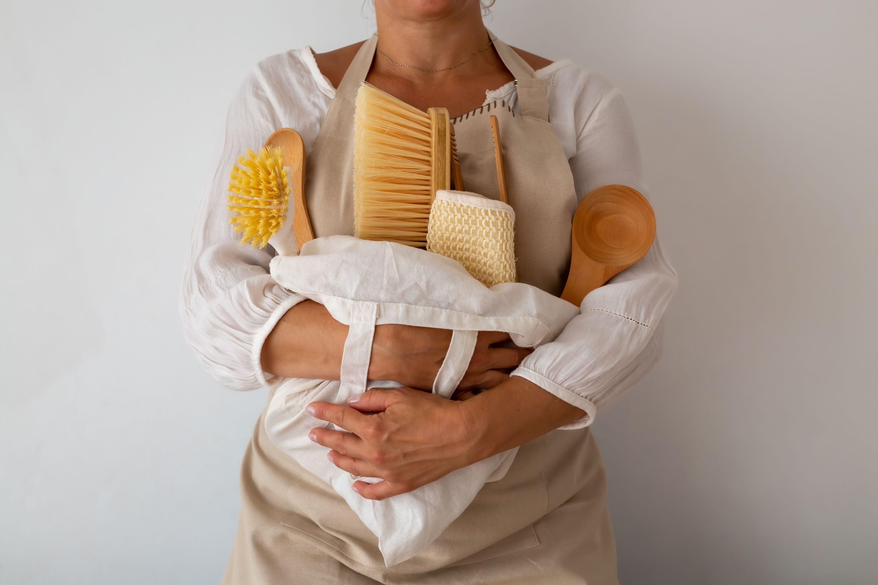 A woman holding eco-friendly accessories for cleaning