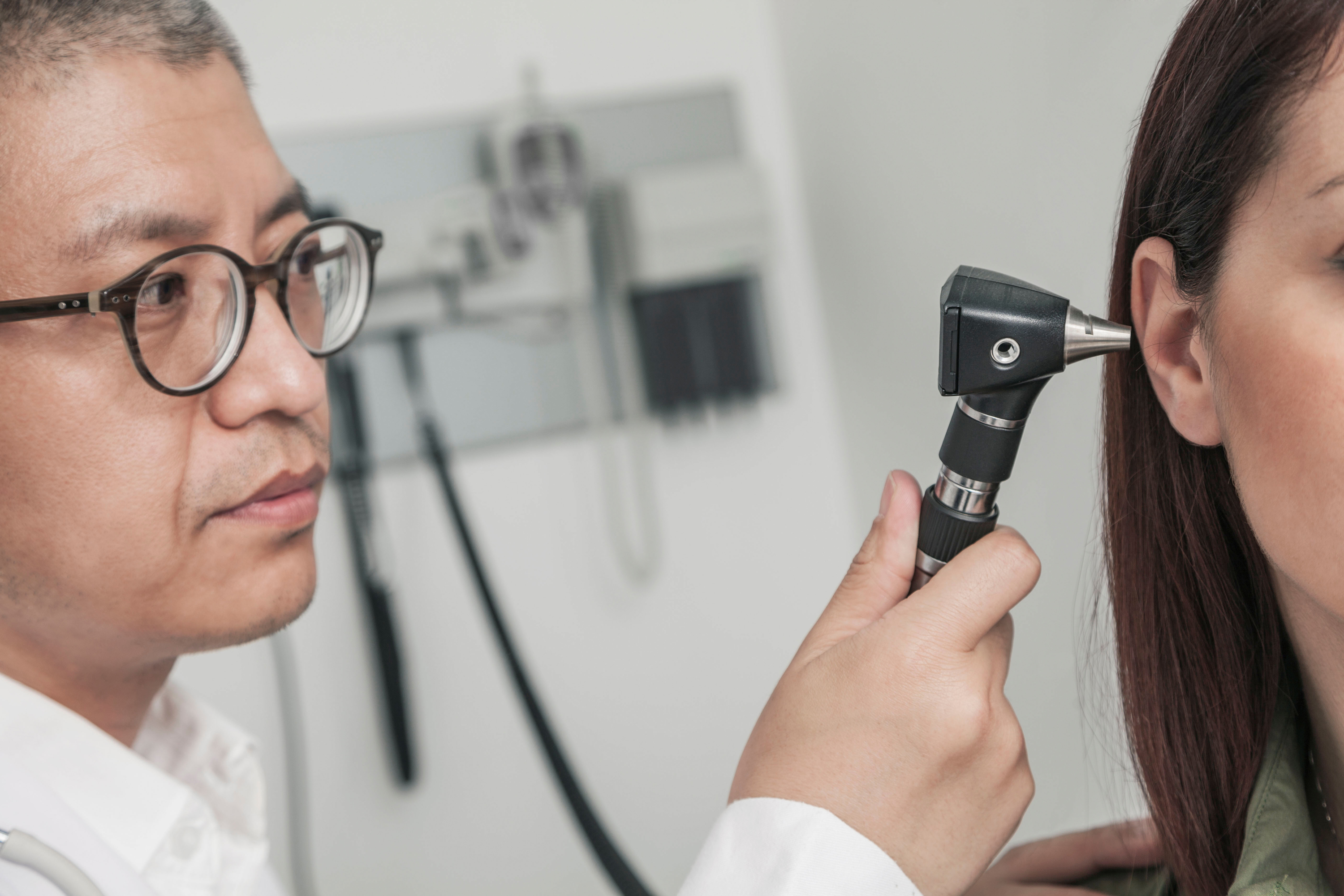 doctor checking the ears of a patient