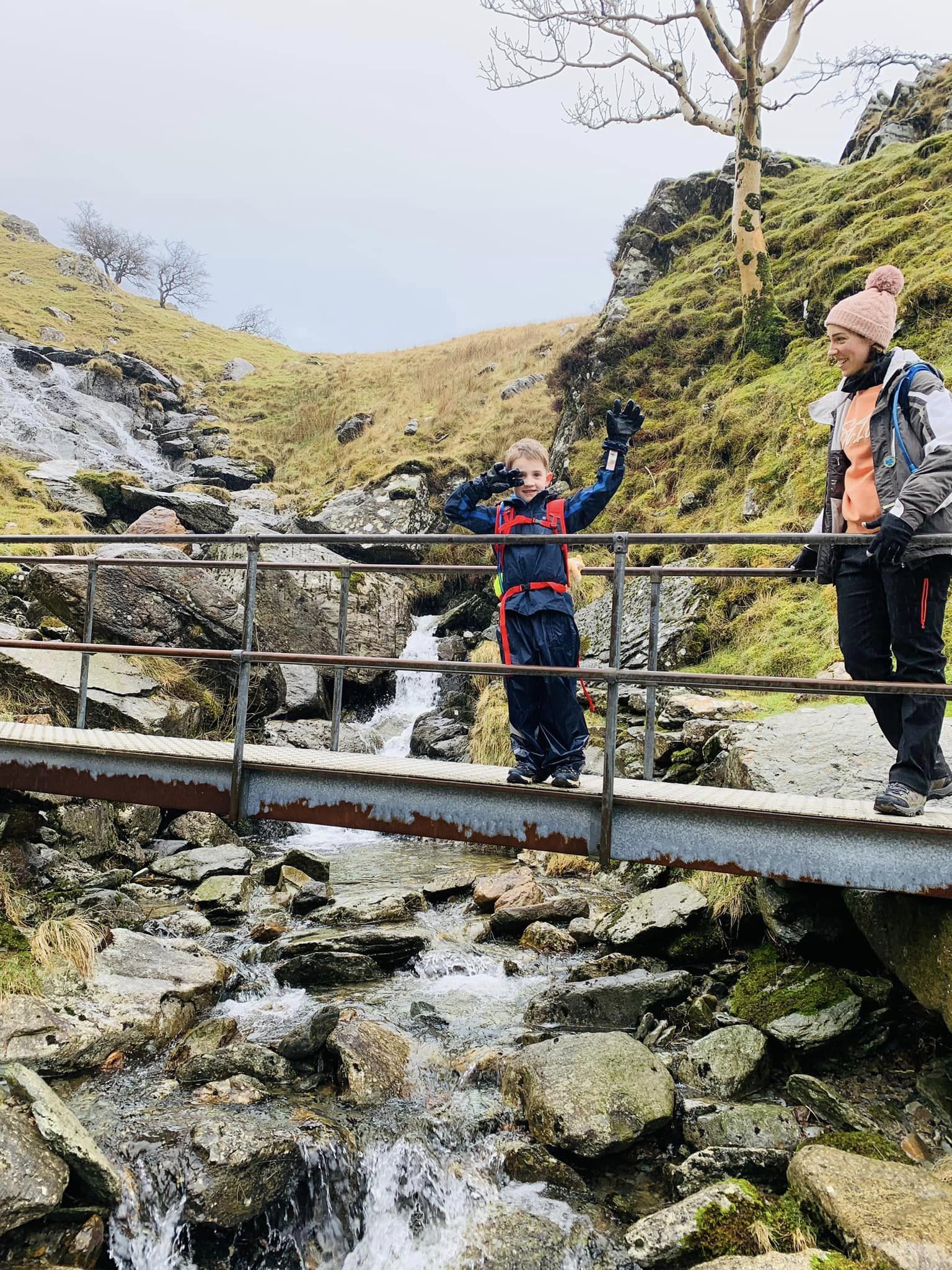 Two people standing on a bridge