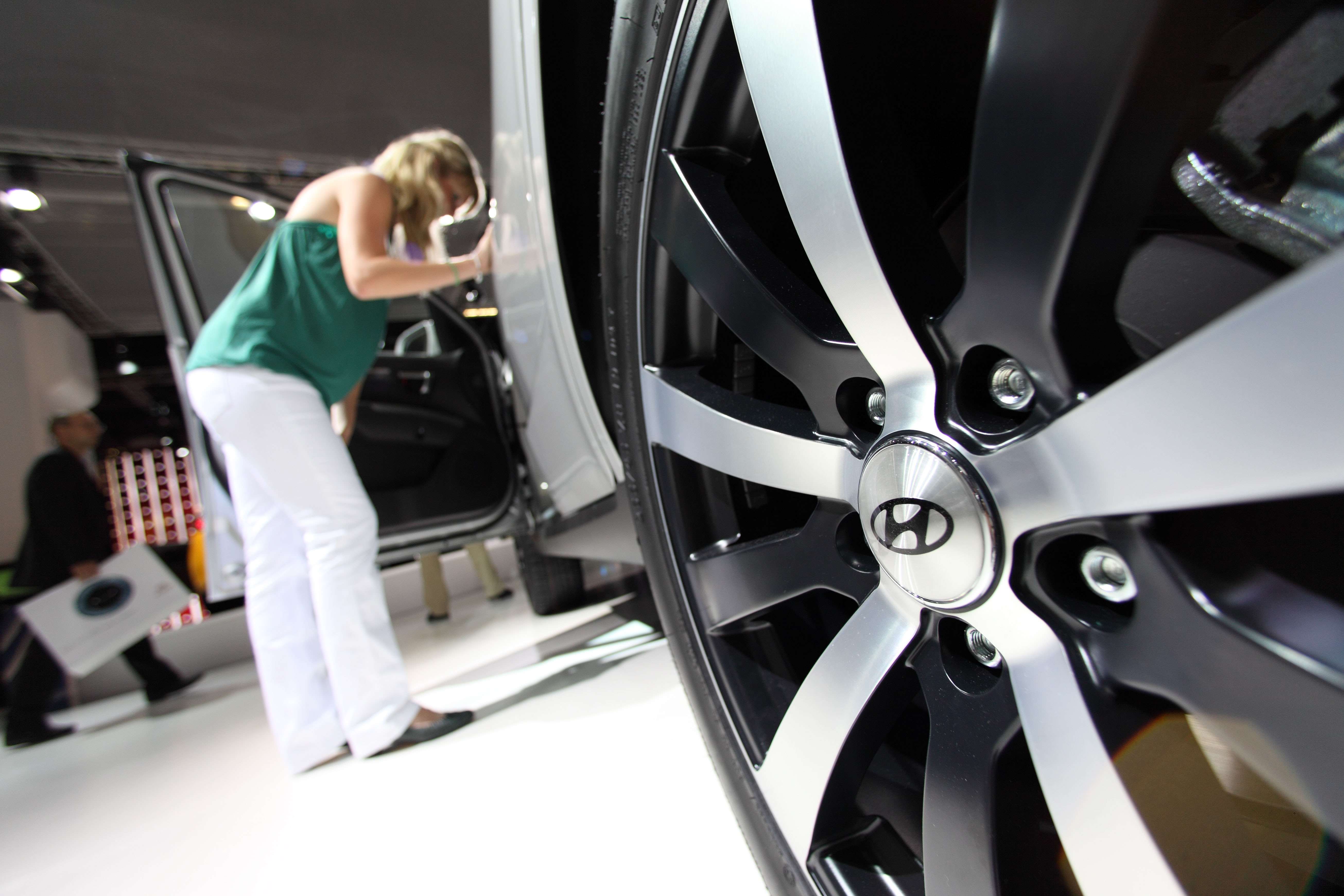 A woman looks at a Hyundai car