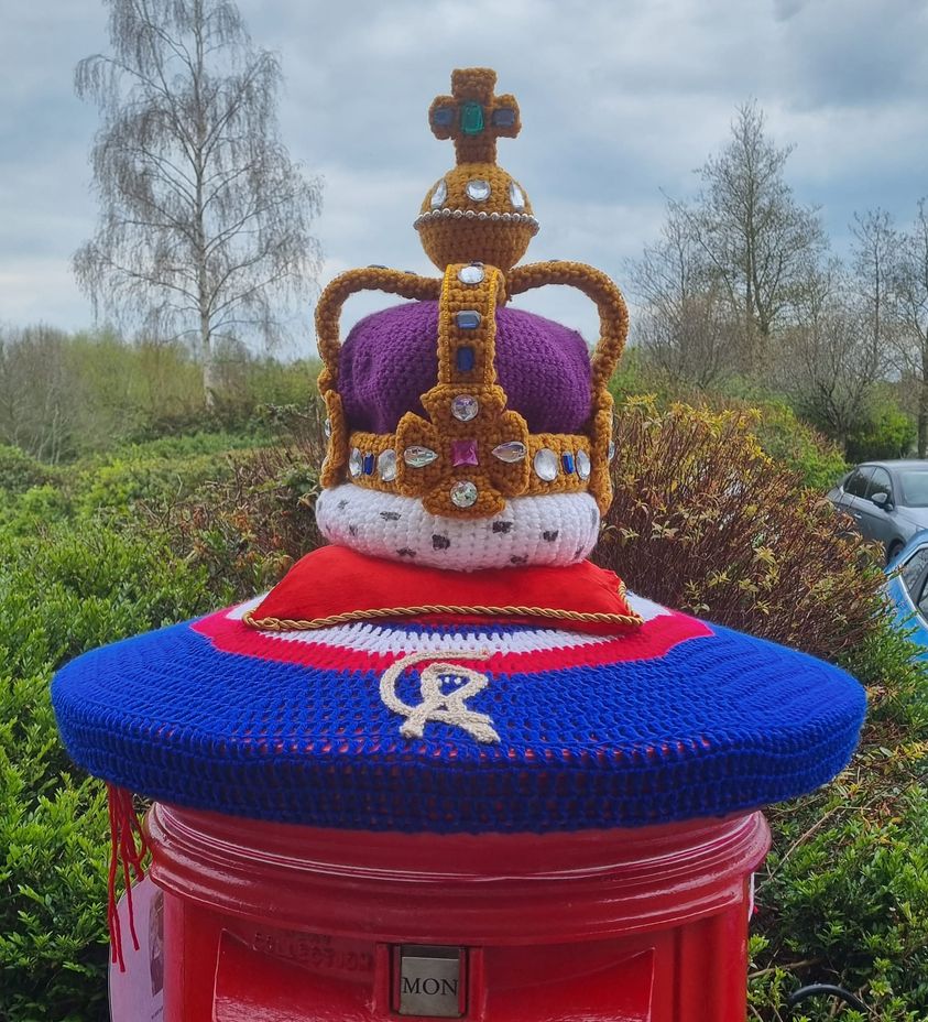 Crocheted crown on top of postbox