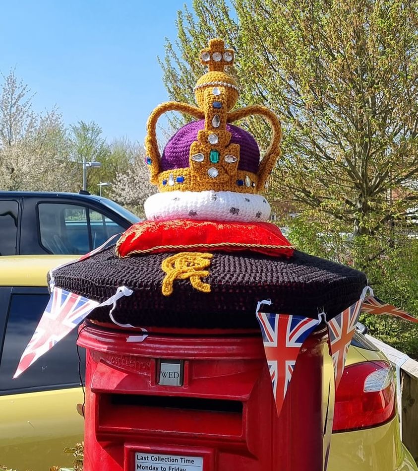 Crocheted crown on top of postbox