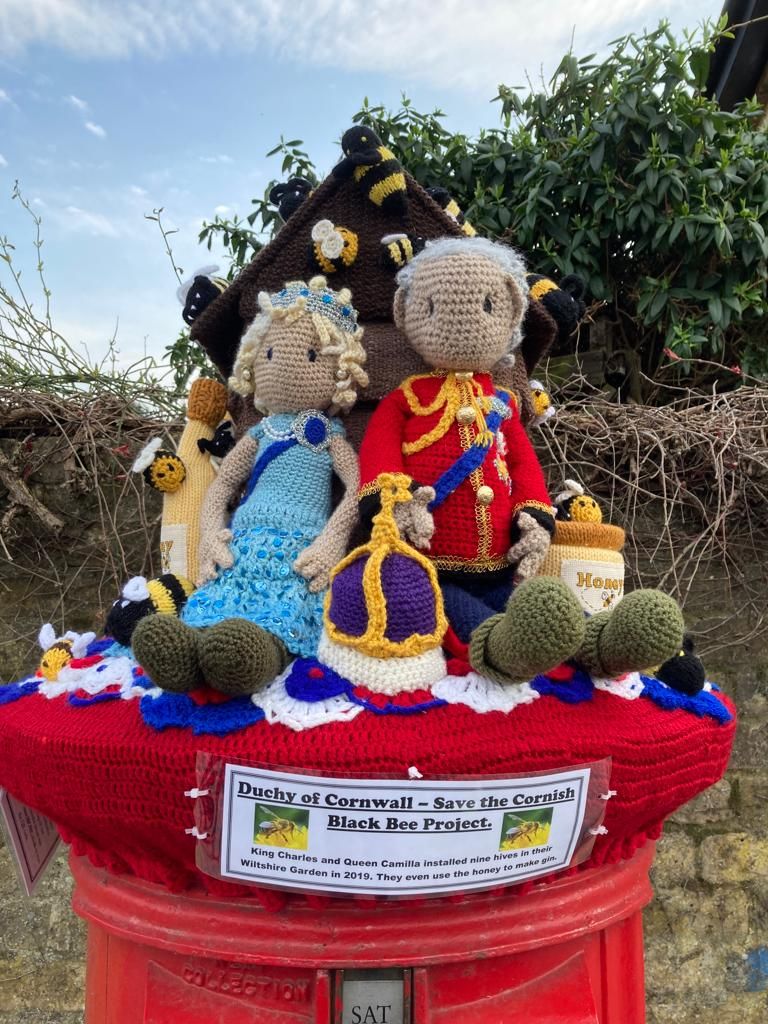 Woman and man on top of postbox