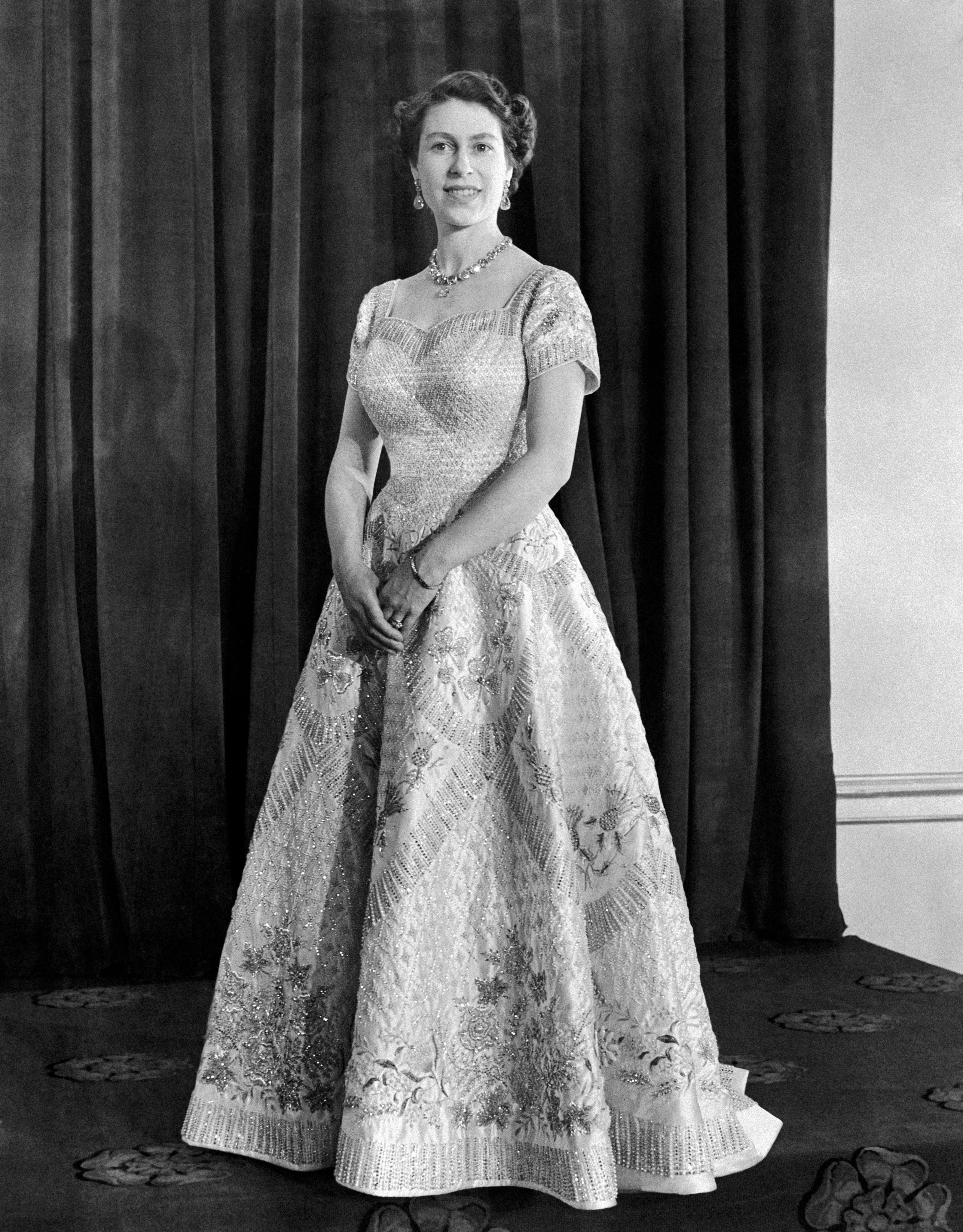 Queen Elizabeth II, wearing a gown designed by Norman Hartnell for her Coronation.