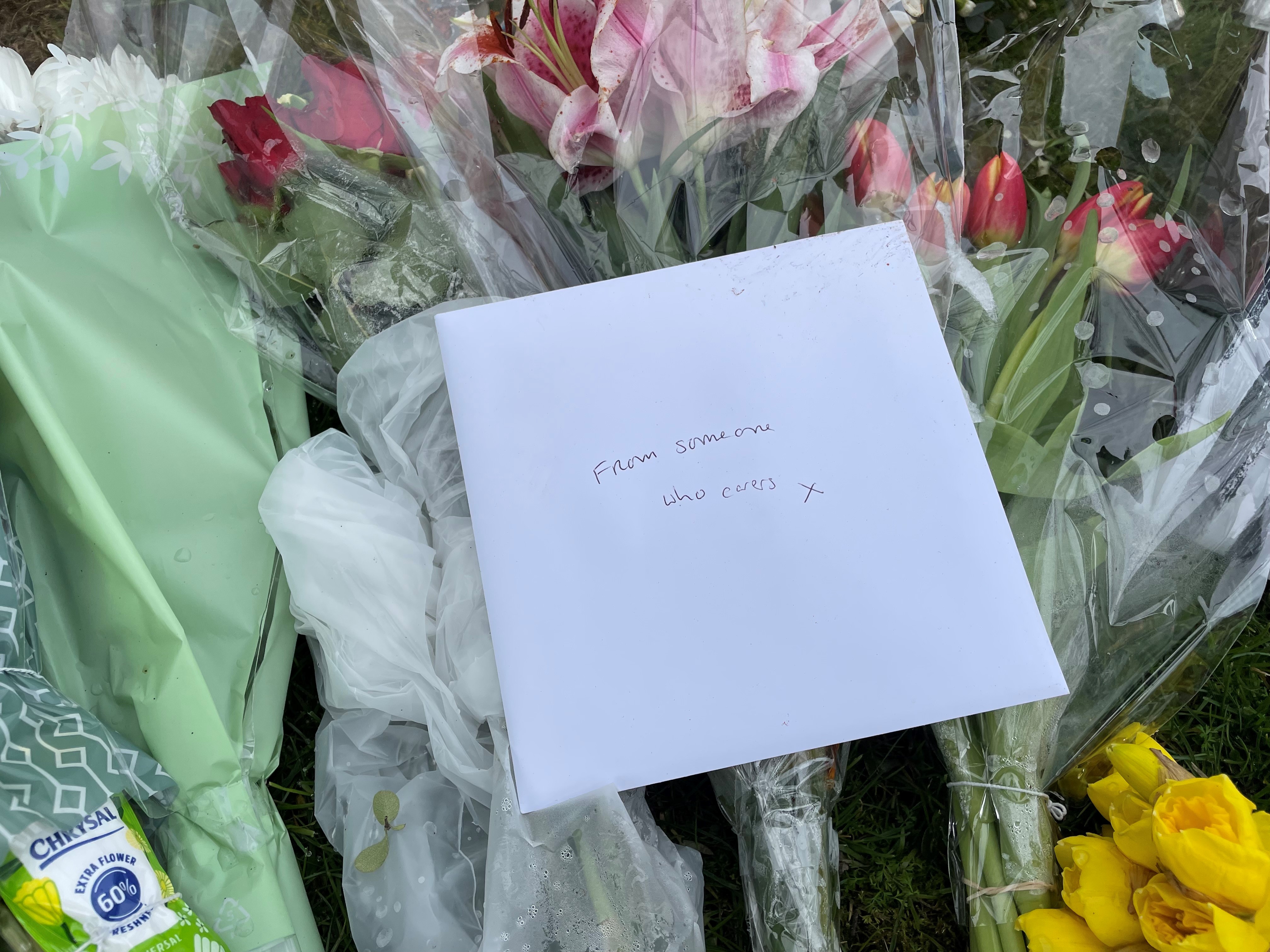Floral tributes in Grayson Avenue, Pakefield, Suffolk remains sealed off as police investigate the murder of pensioner Joy Middleditch. (Sam Russell/ PA)
