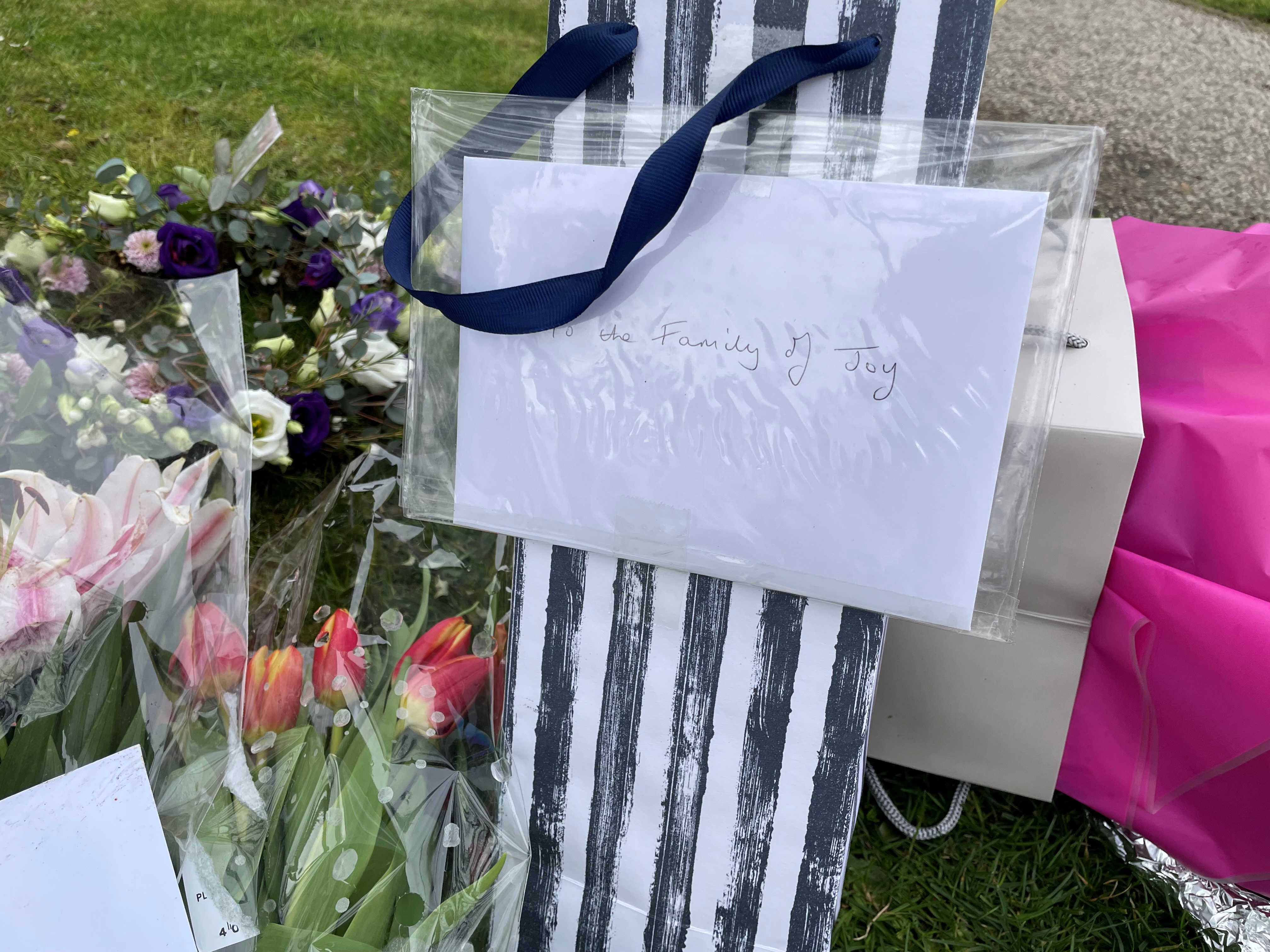 Floral tributes in Grayson Avenue, Pakefield, Suffolk remains sealed off as police investigate the murder of pensioner Joy Middleditch. (Sam Russell/ PA)